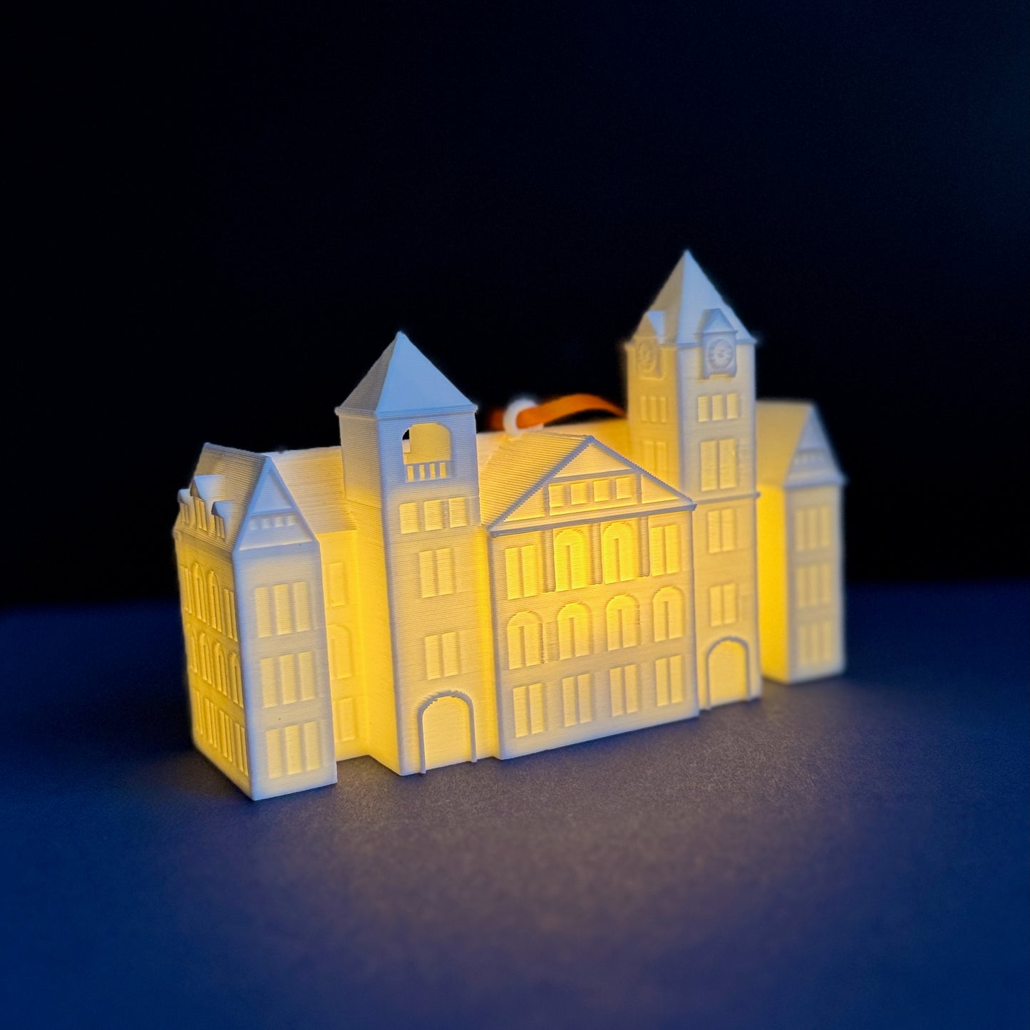 The Auburn University ornament featuring Samford Hall, shown with an LED light.