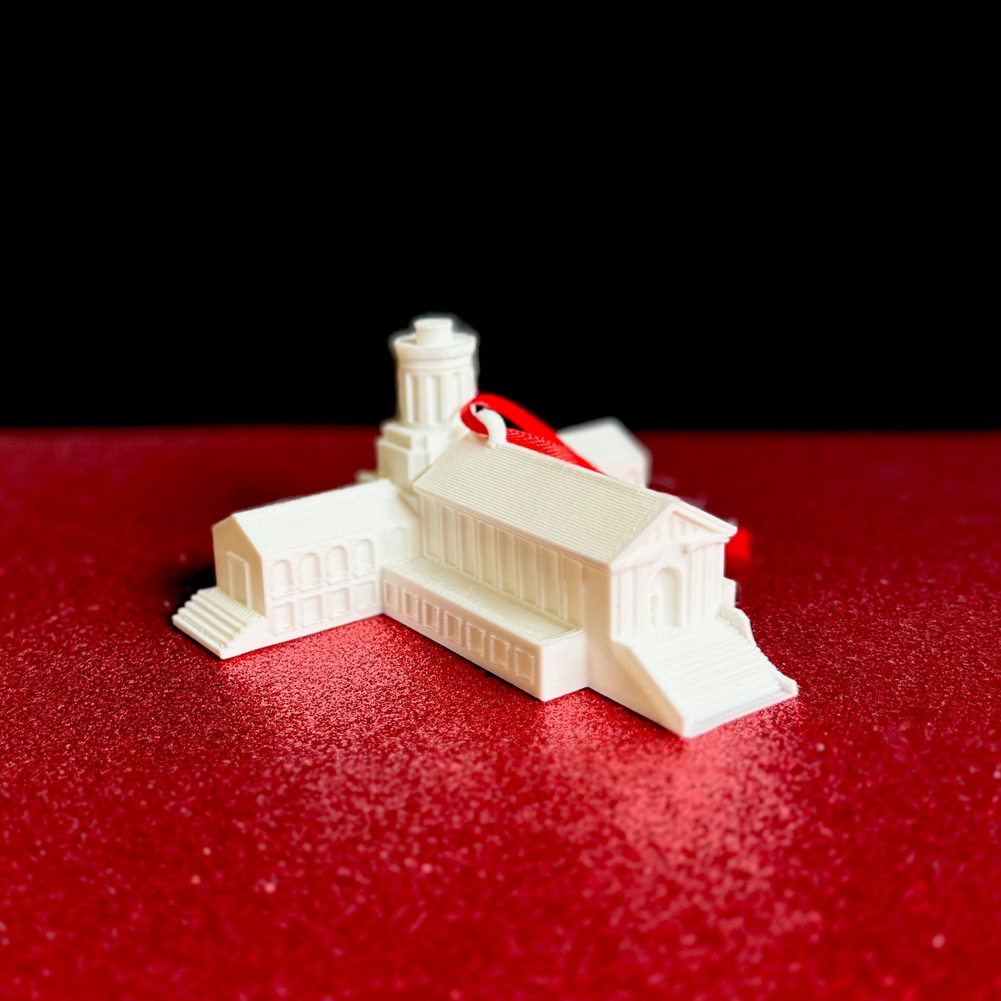 The college ornament for Carnegie Mellon, shown against a red background.