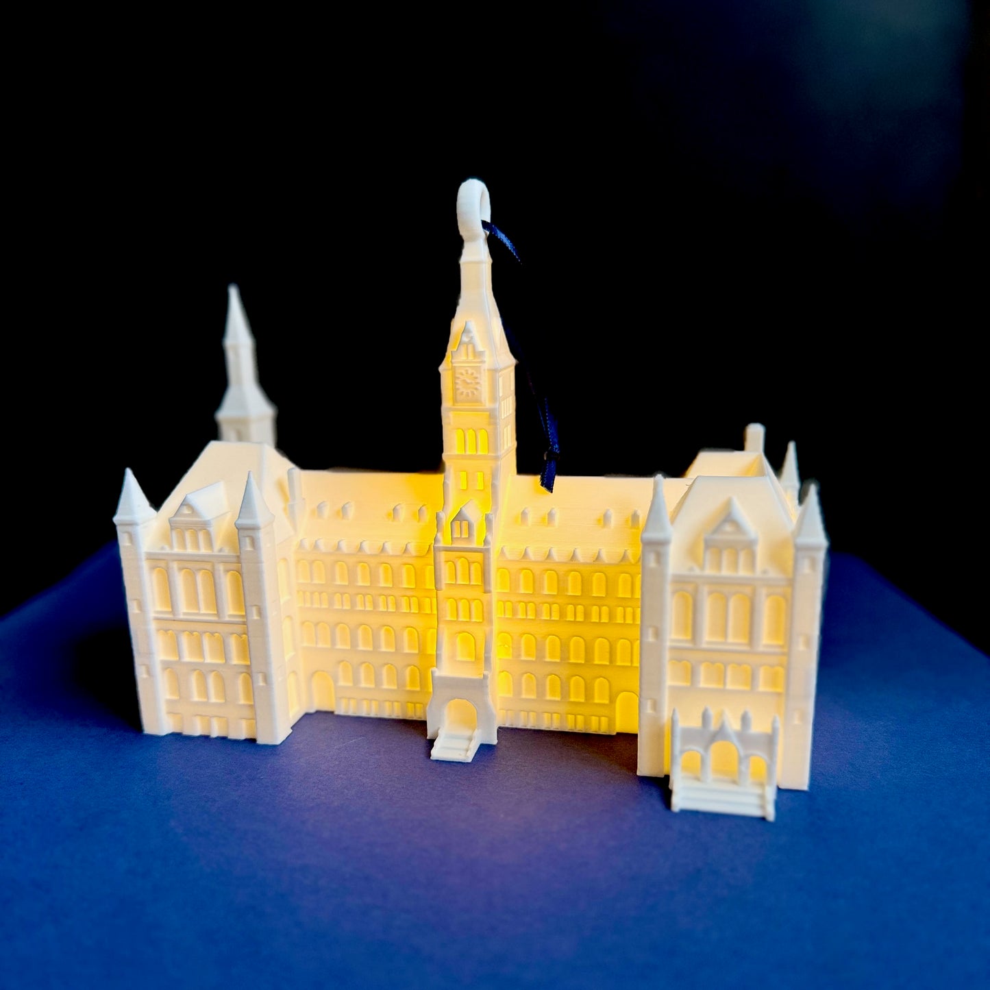 The Healy Hall ornament for Georgetown University alumni, shown against a background of school colors.