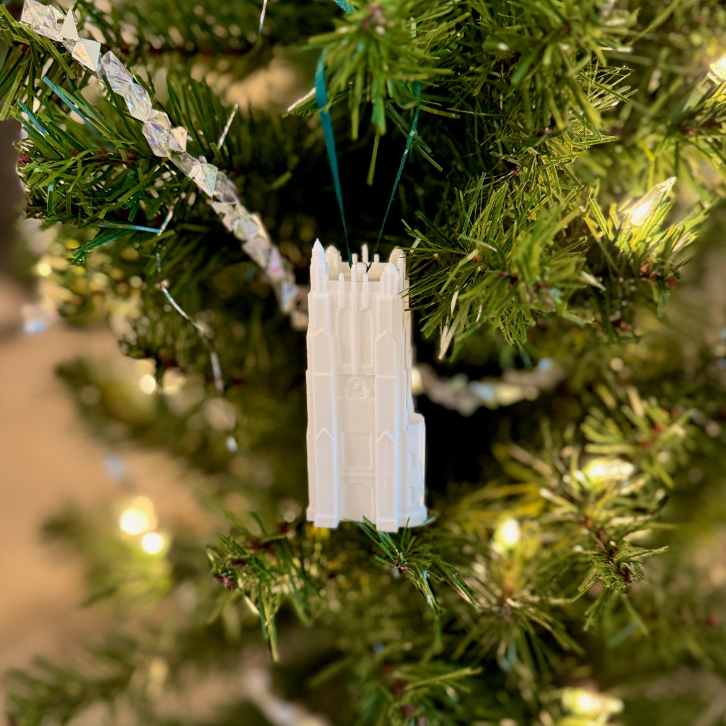 The Michigan State Christmas ornament depicting the bell tower, shown on a Spartans tree.