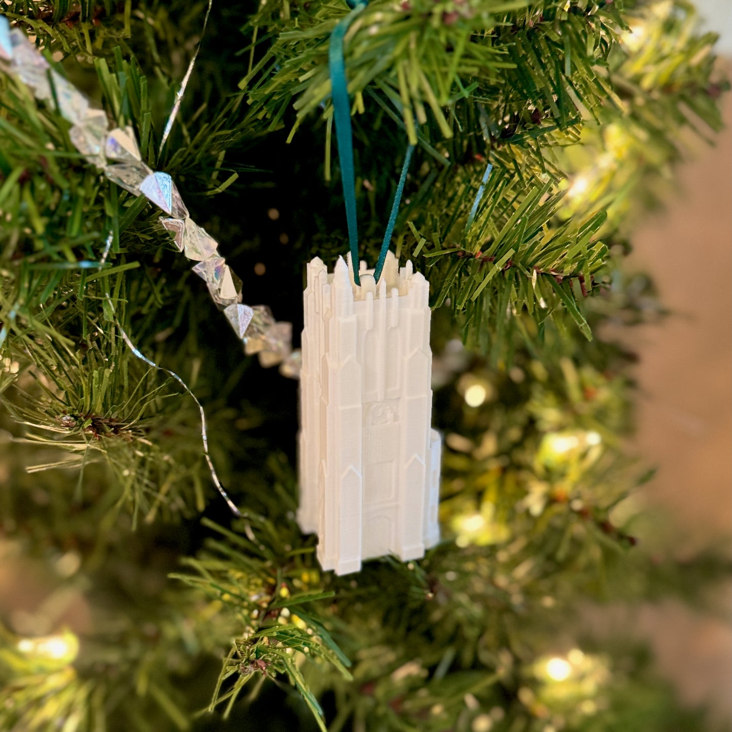 The Michigan State ornament of the MSU campus building, shown on a Christmas tree.