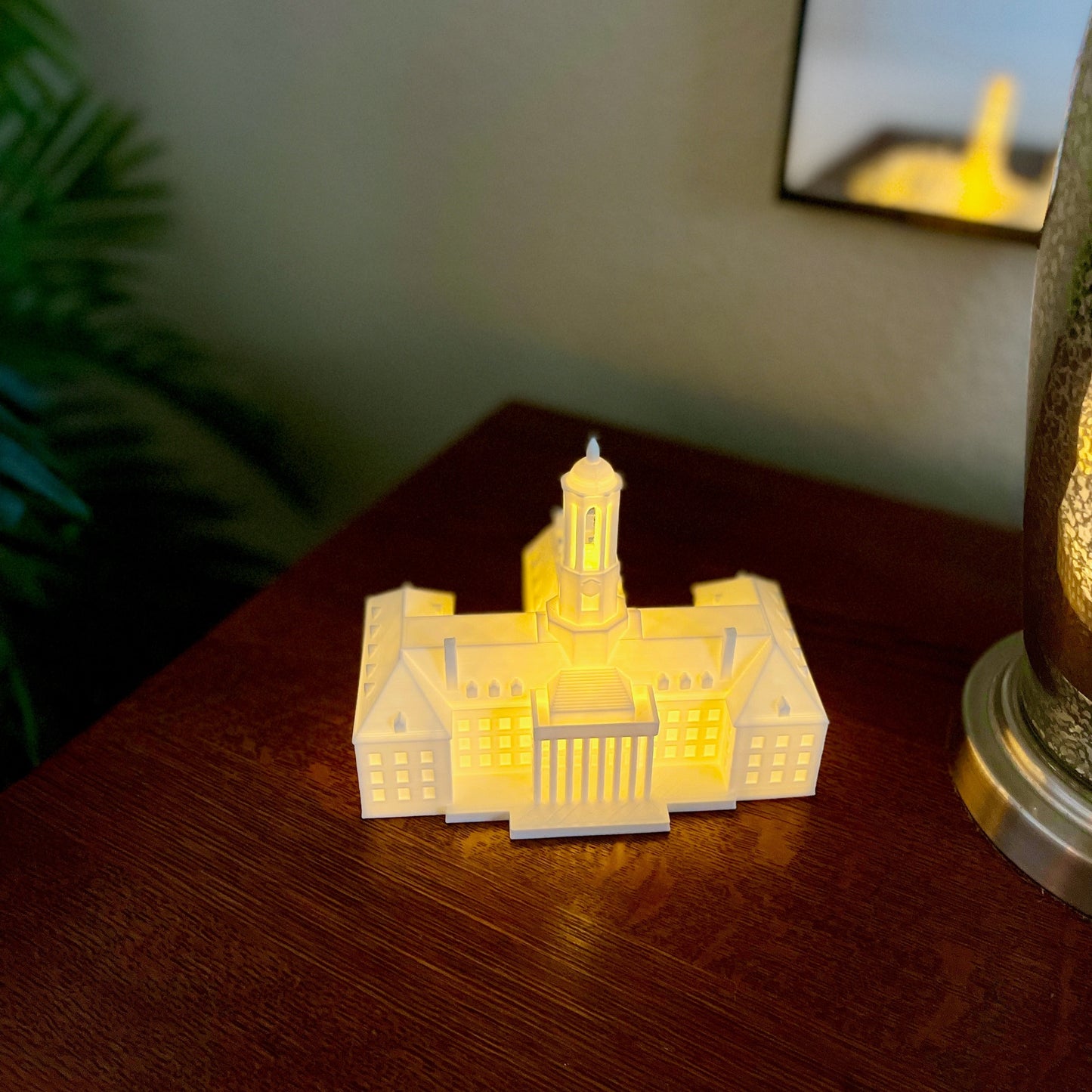 The lighed Penn State dorm decoration, shown on a bedroom side table.