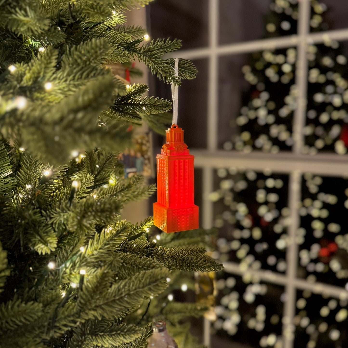 The UT Tower ornament with a light, and shown in burnt orange.