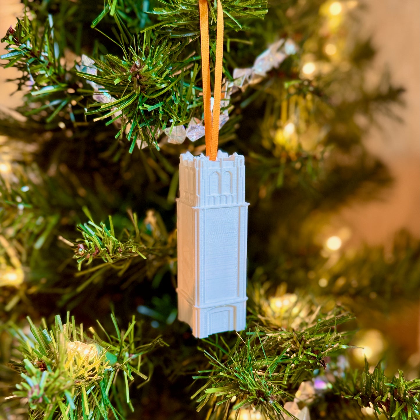 The University of Florida Century tower ornament shown on a Gators tree.