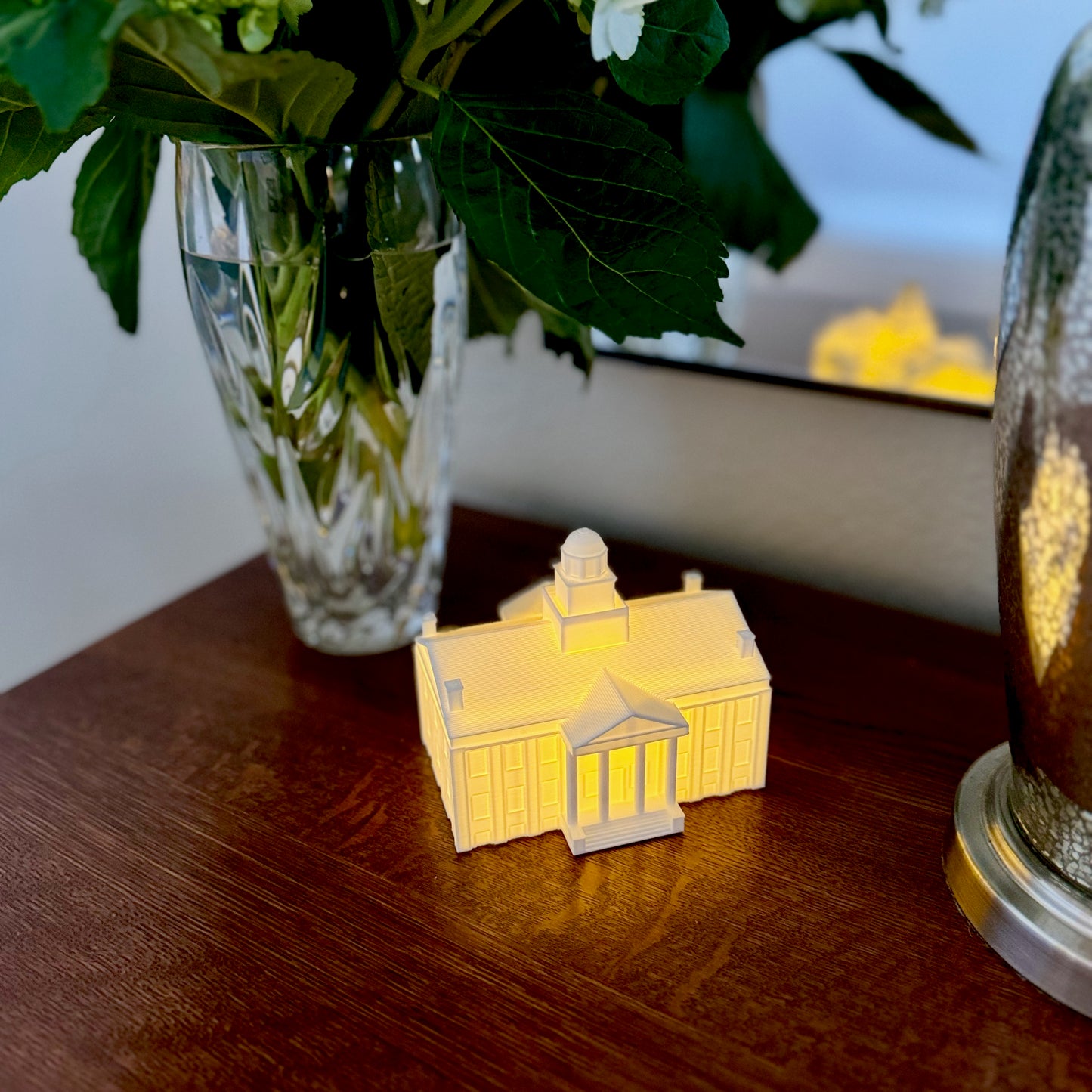 The Iowa cake topper, used as dorm decor and shown on a bedroom side table.