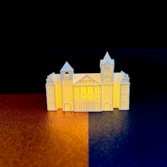 The Auburn Samford Hall lighted figurine, shown against a background of school colors.