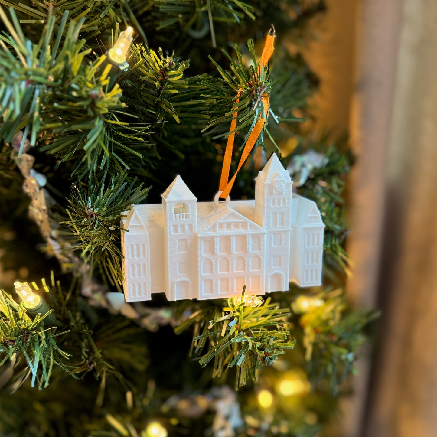 Side view of the Auburn Christmas ornament, designed in honor of Samford Hall and shown on an Auburn tree.