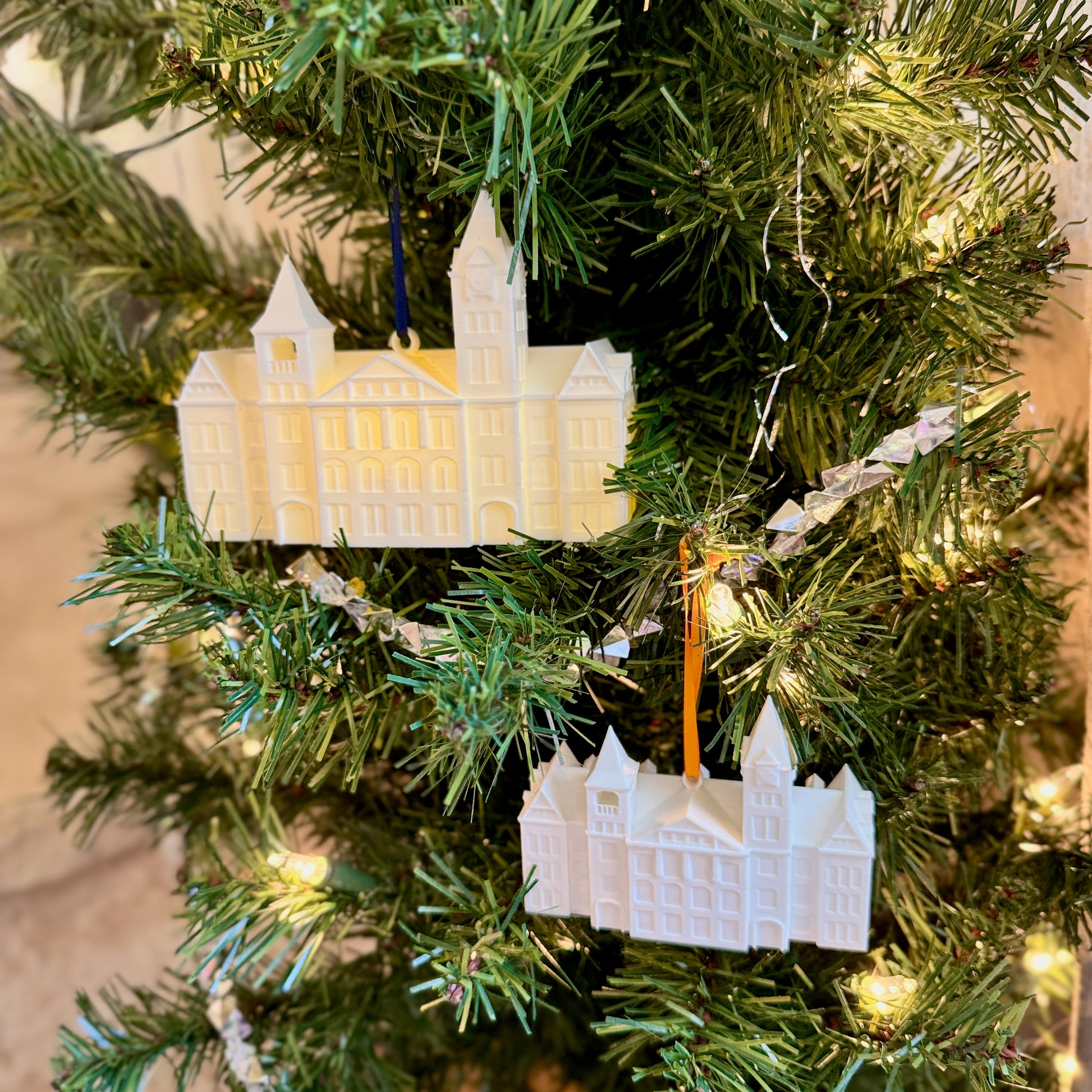 Two sizes of Auburn ornaments – large lighted and small unlit – displayed side by side