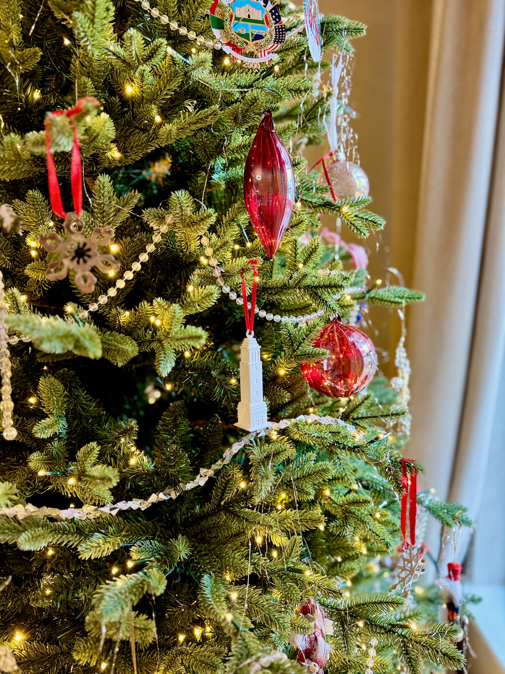 Bama ornament of Denny Chimes shown on a Christmas tree.