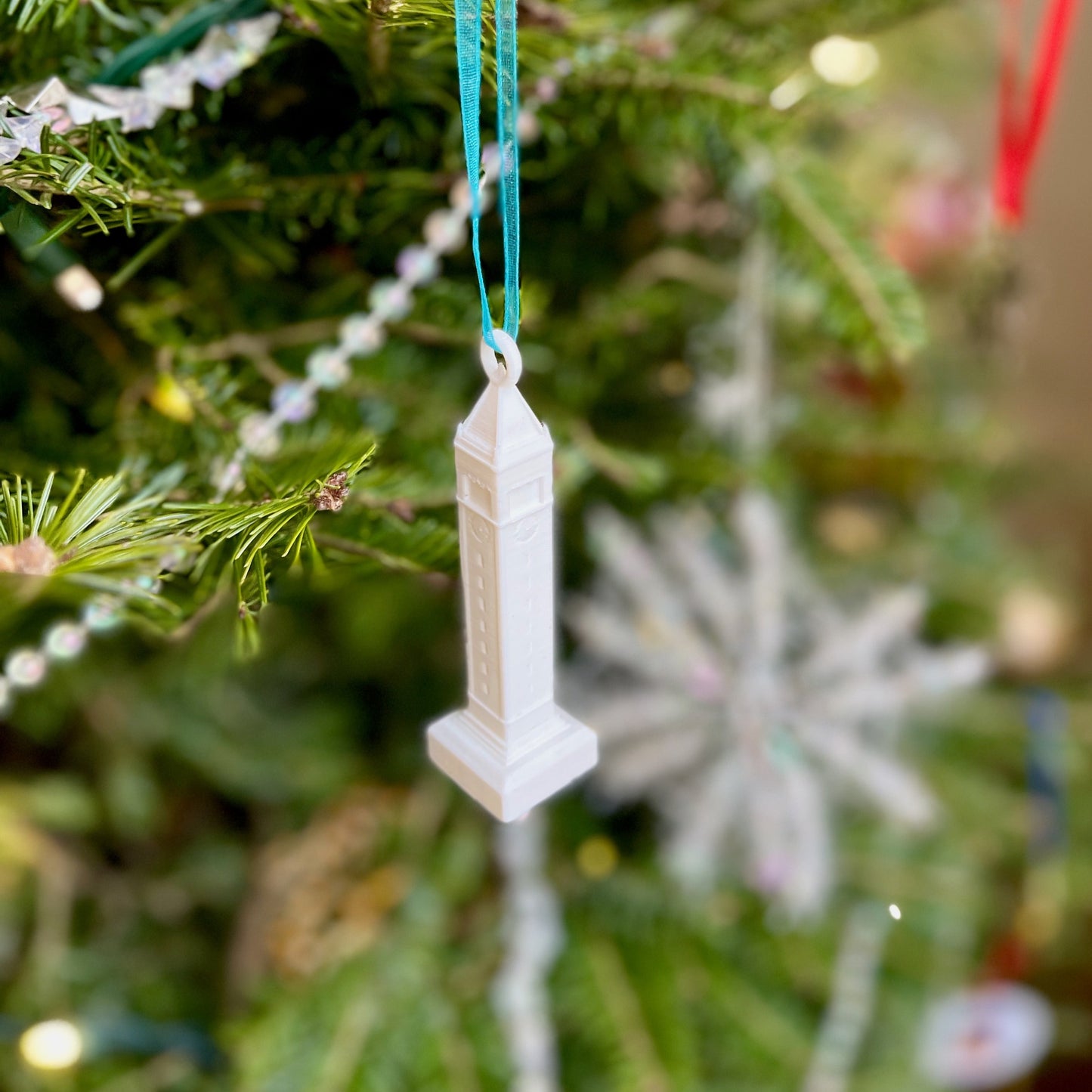 The Berkeley ornament of Sather tower, shown on a Christmas tree.