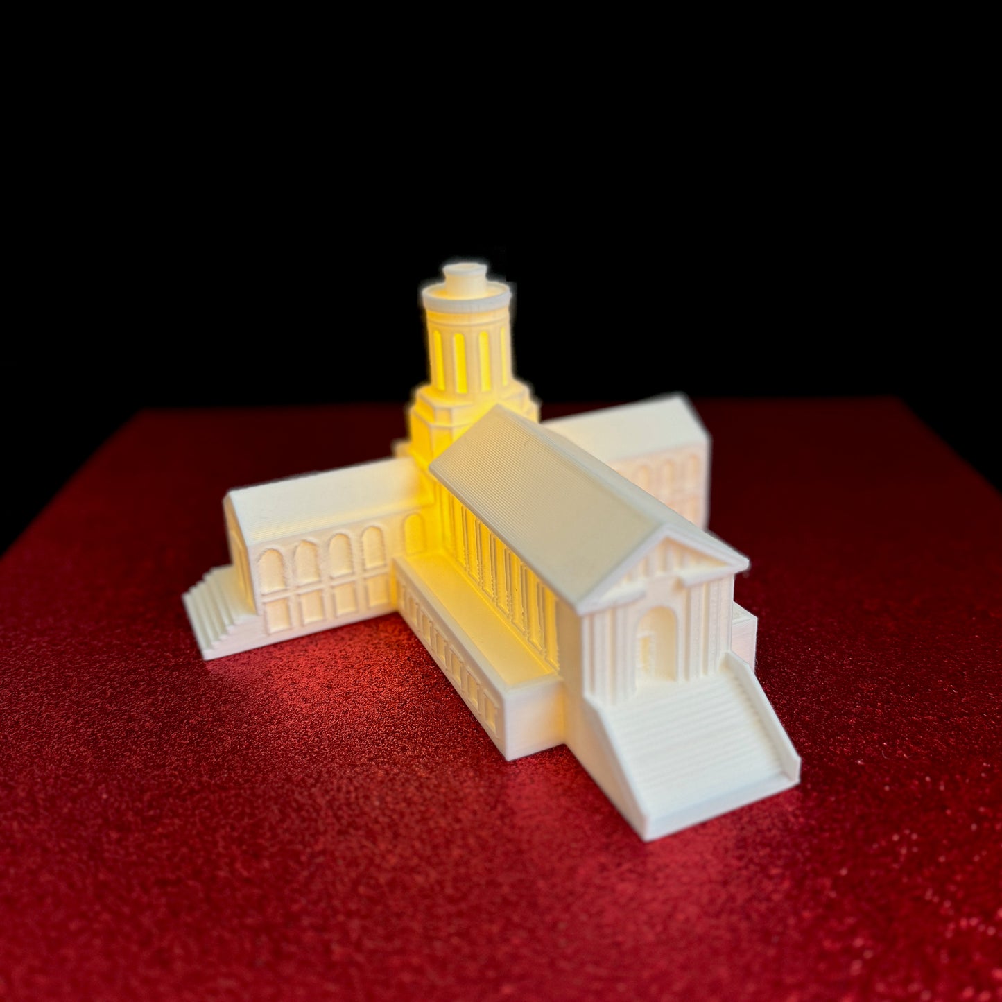 The Carnegie Mellon figurine, used as a graduation gift and shown on a red background.