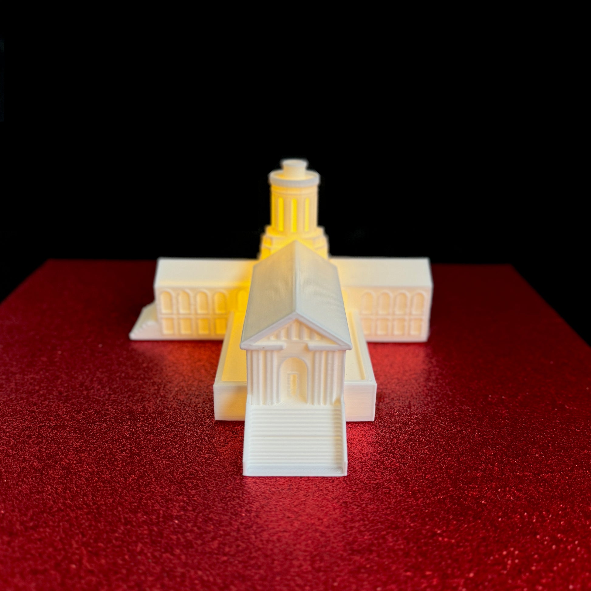 Front view of the Carnegie Mellon keepsake, designed as a figurine of the Hammerschlag Hall building on the Carnegie Mellon campus.