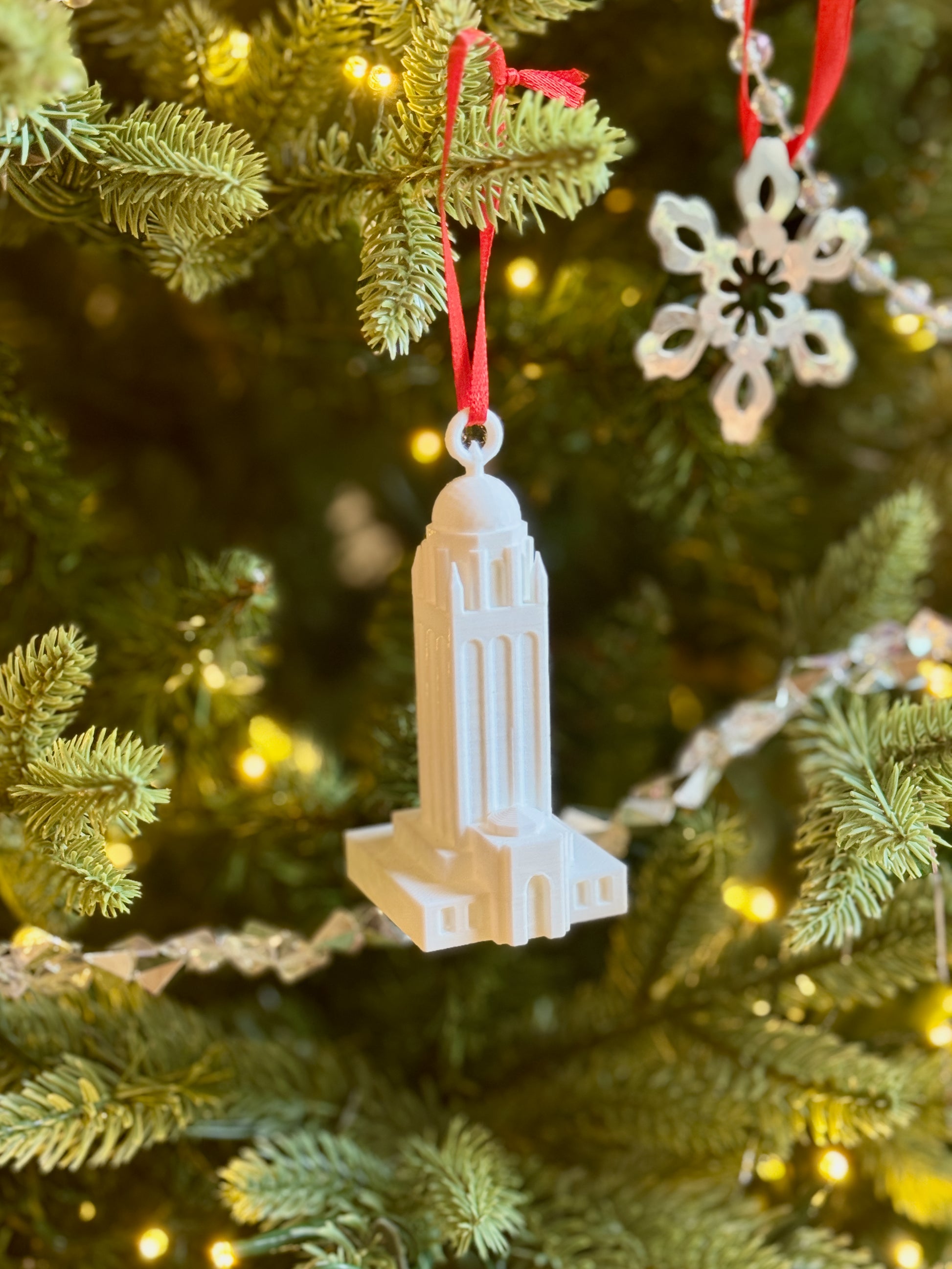 The Stanford college ornament of Hoover tower shown on a tree.