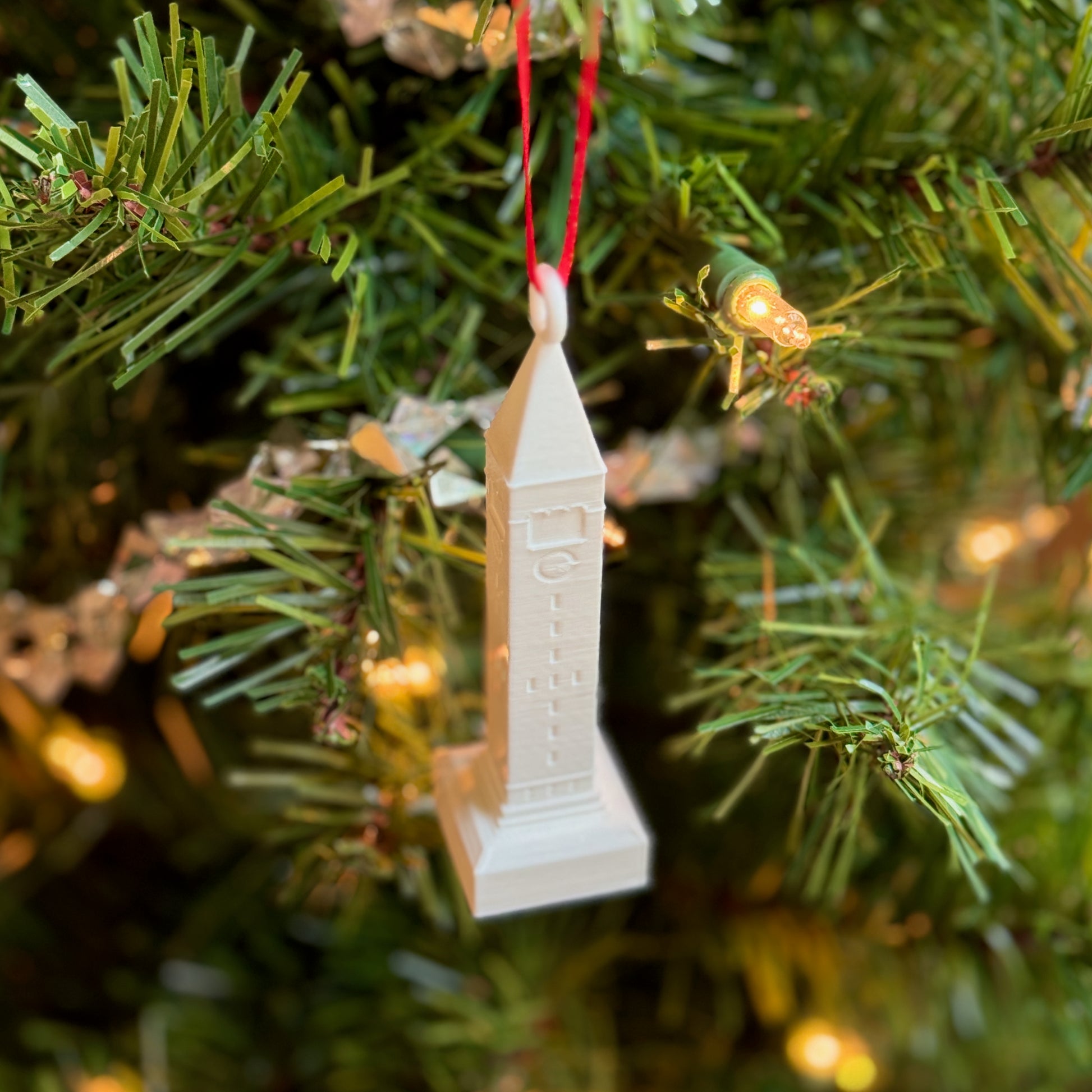 the Cornell Christmas Ornament on a tree.