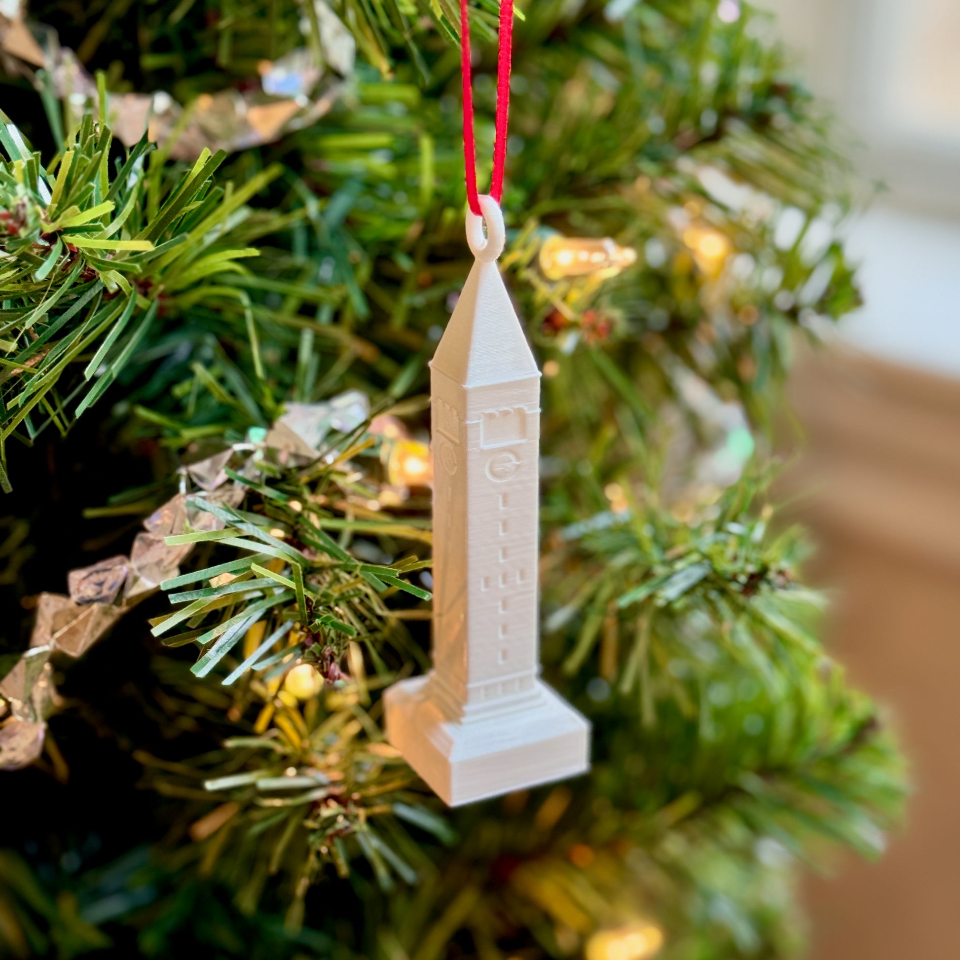 The Cornell McGraw Tower ornament shown on a Christmas tree.