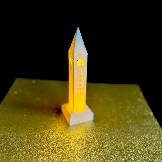 The Cornell University light, shown against a gold background.