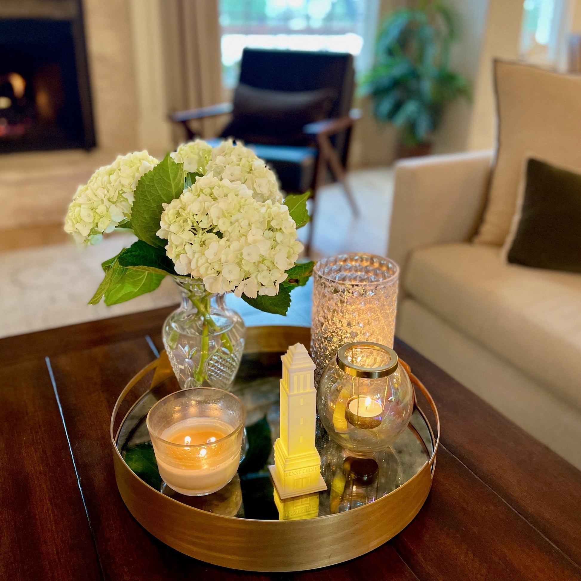 The University of Alabama college acceptance gift, designed as the Denny Chimes tower and shown on a tray in a living room.