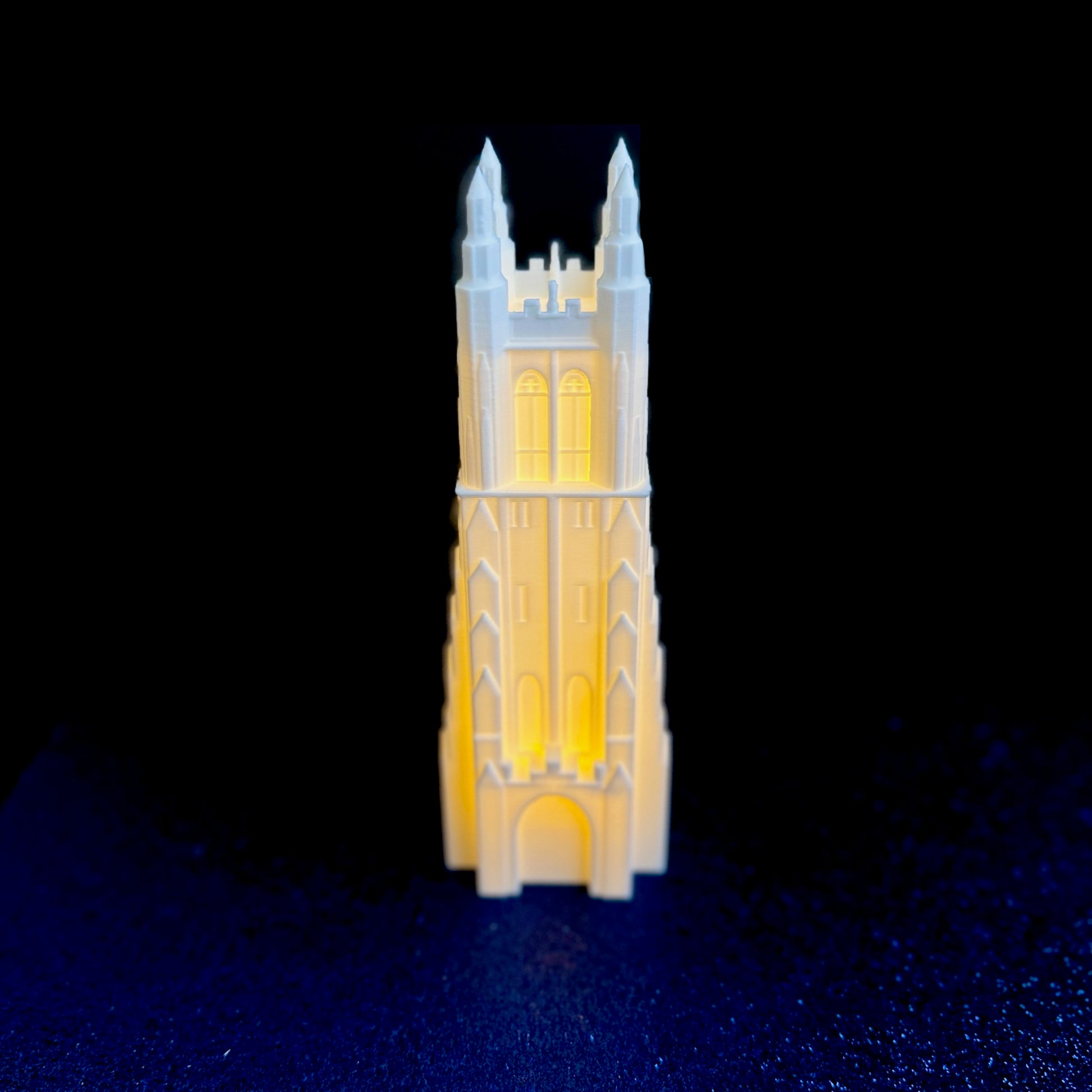 The Duke Chapel figurine, shown on a blue background.