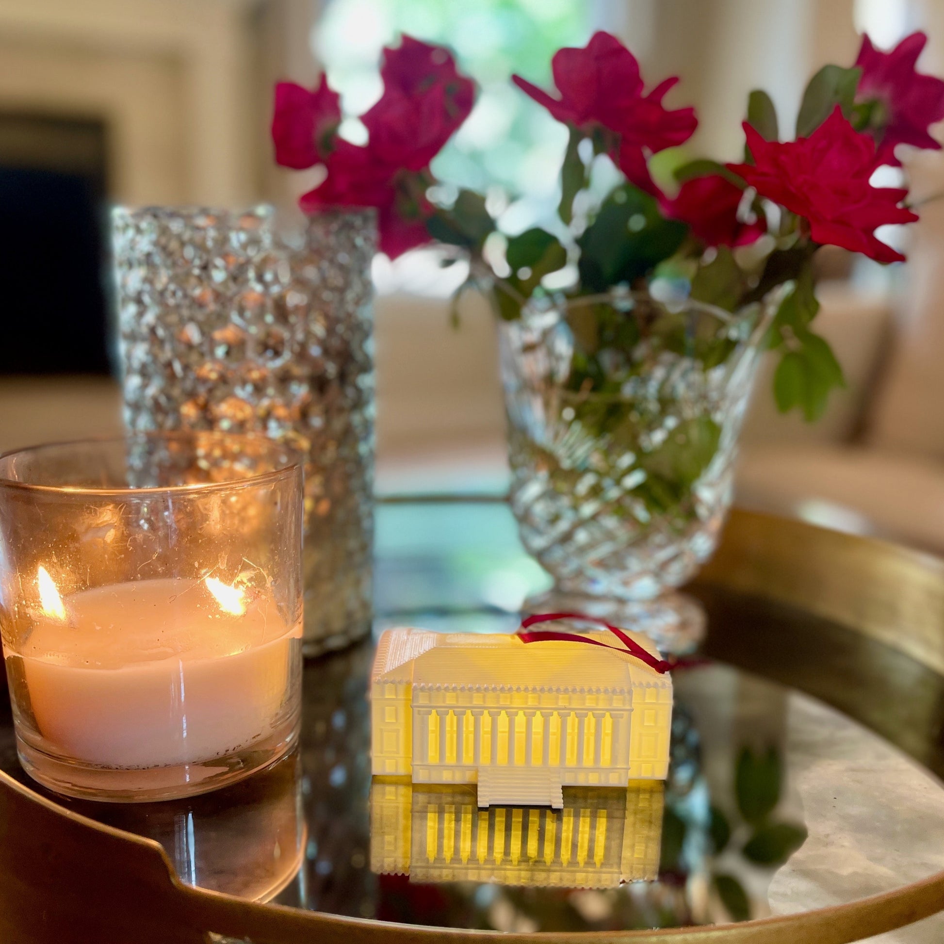 The lighted TAMU ornament, shown on a living room table.