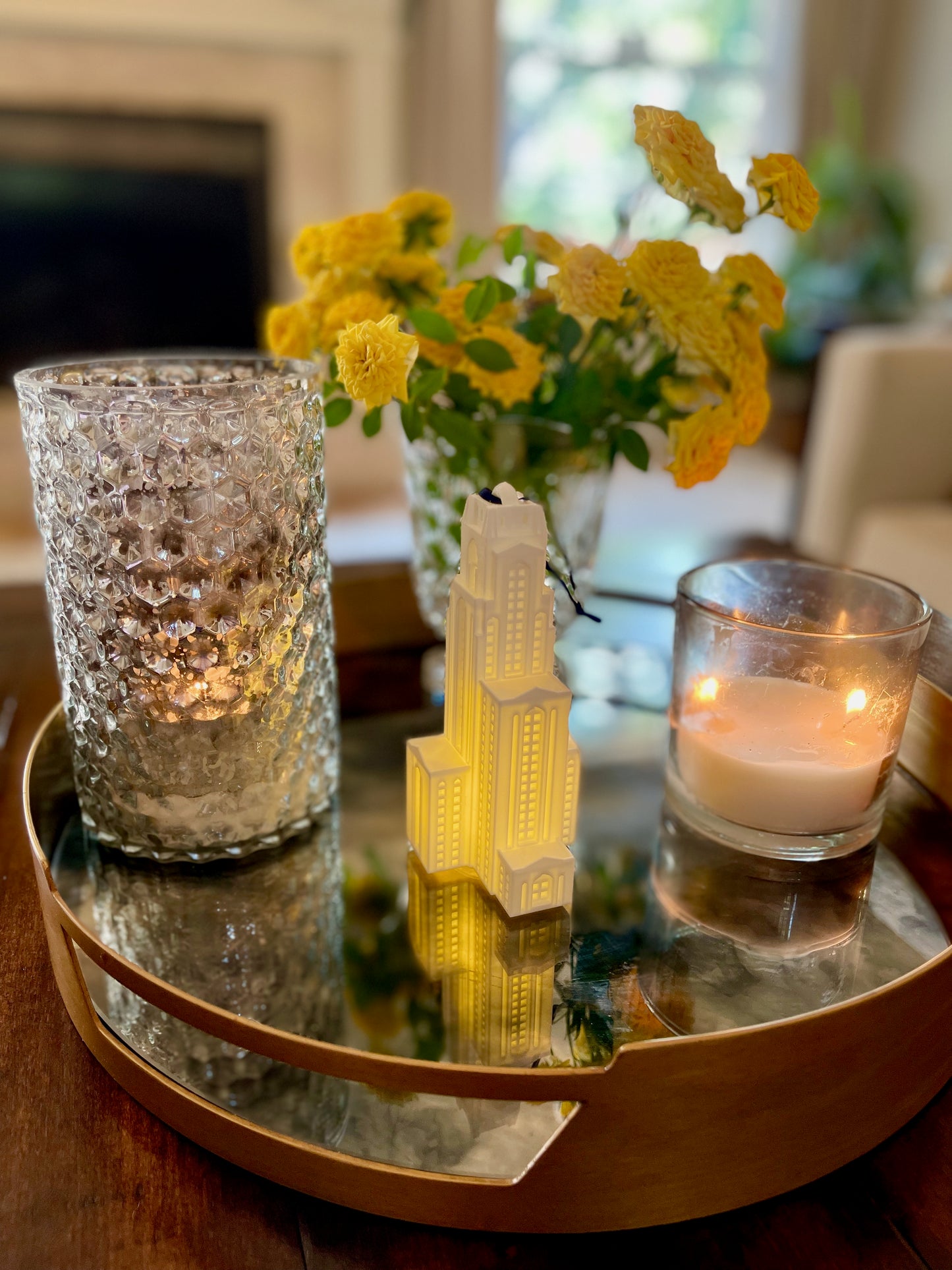 The University of Pittsburgh Christmas ornament, shown in a home and styled on a tray.