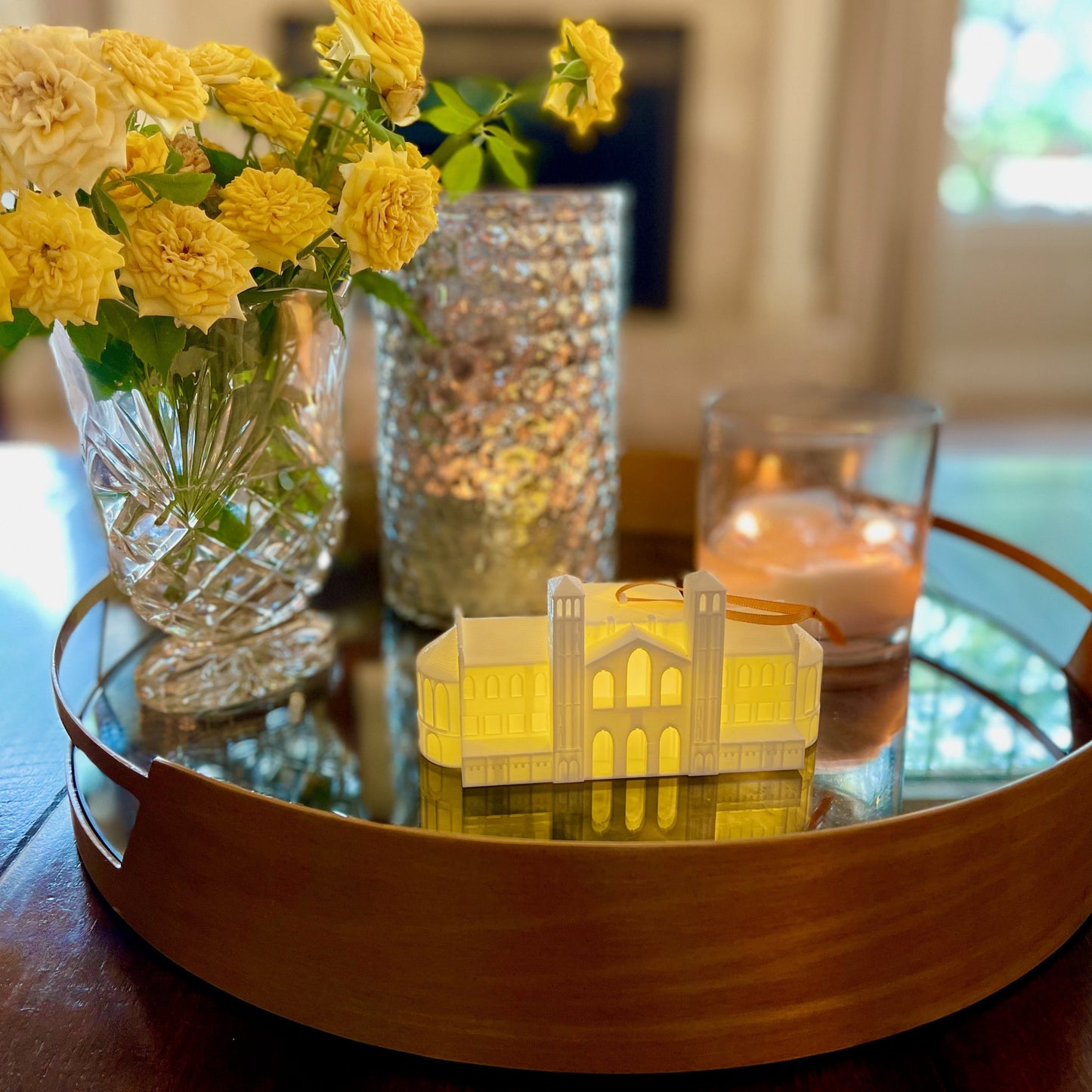 The UCLA lighted ornament of Royce Hall, shown on a living room tray.