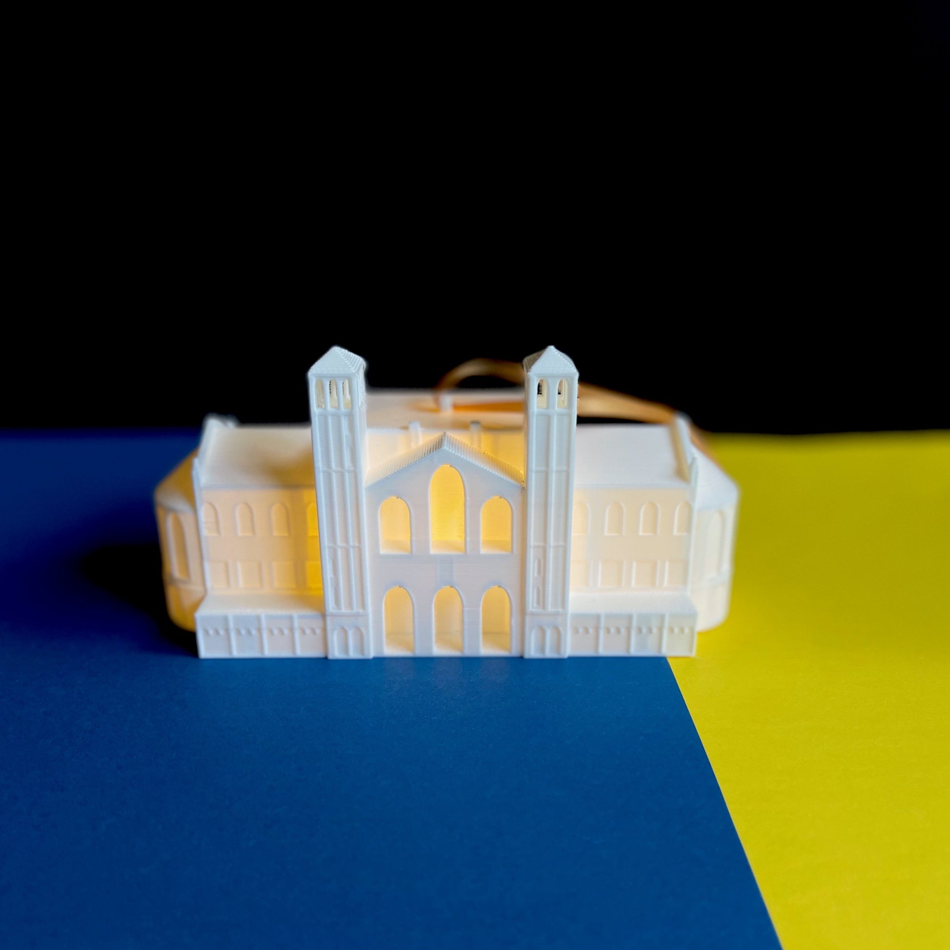 The UCLA ornament of the UCLA campus, shown in a background of school colors.