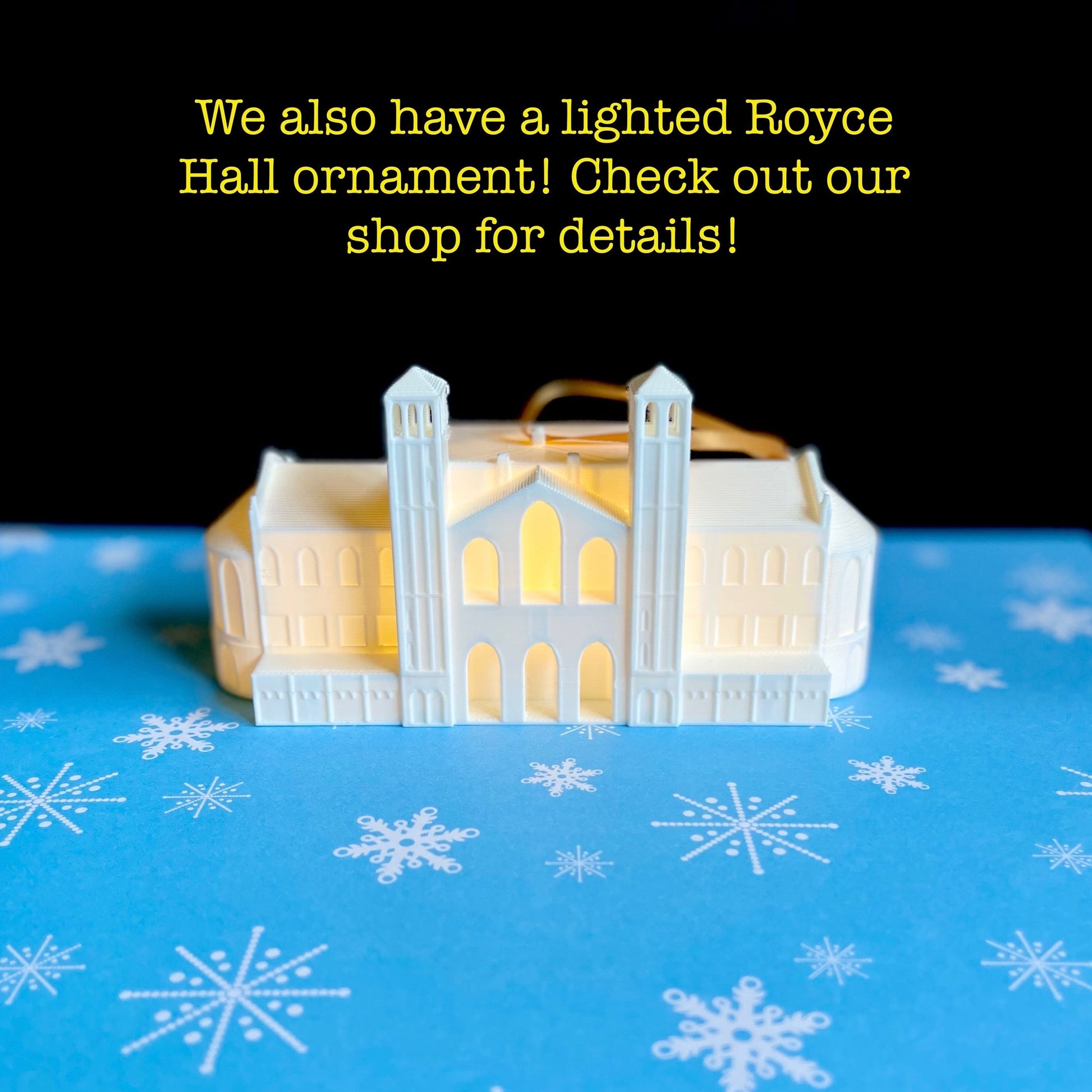 The UCLA Royce Hall ornament, shown against a blue holiday background.