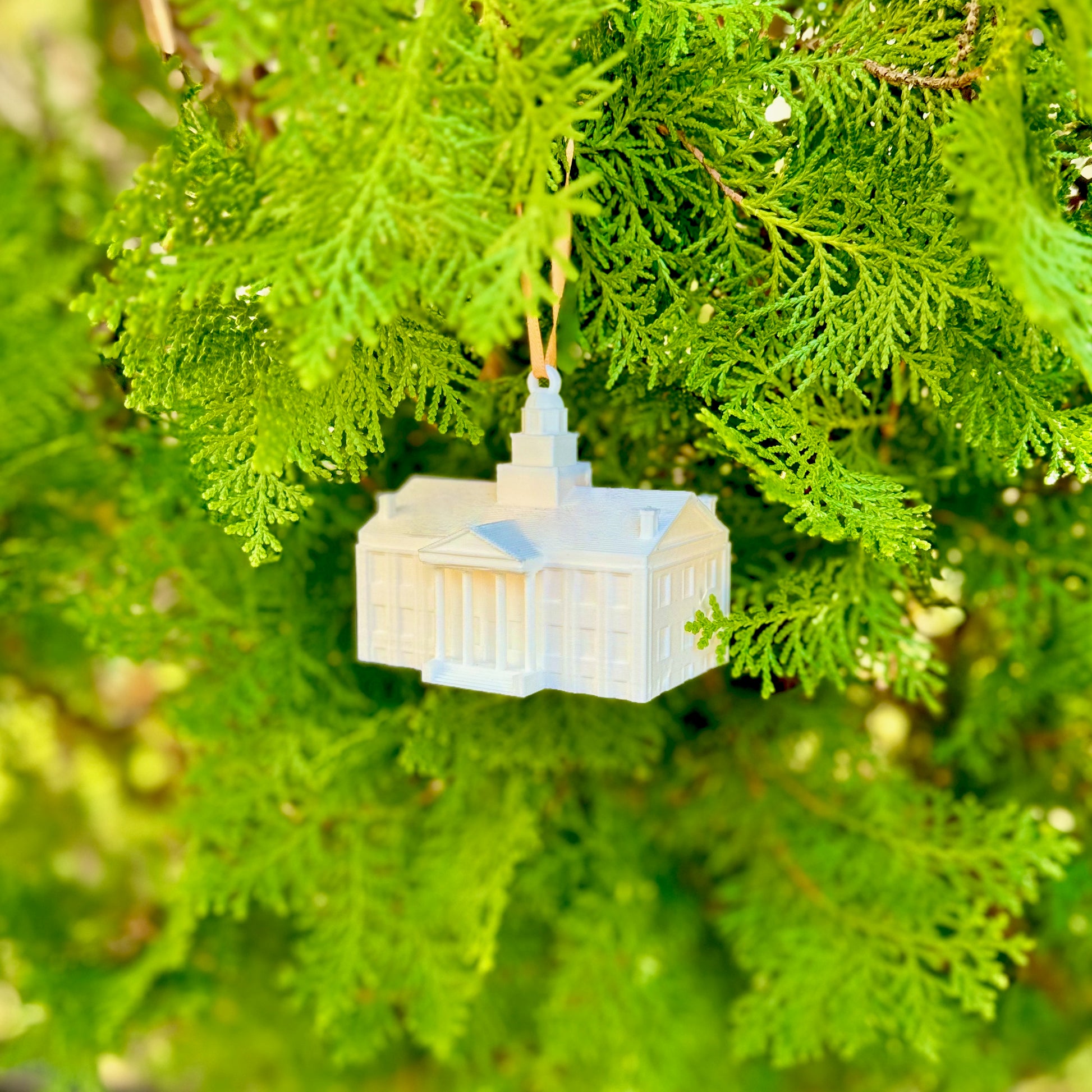 The University of Iowa ornament of the Old Capitol, shown on a Christmas tree.