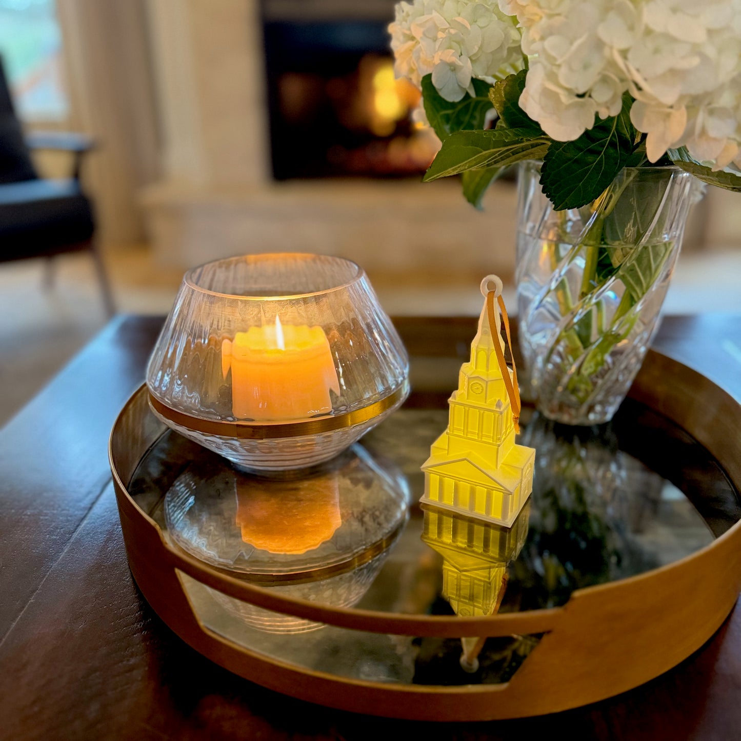 The lighted Wake Forest ornament of Wait Chapel, shown on a living room tray.