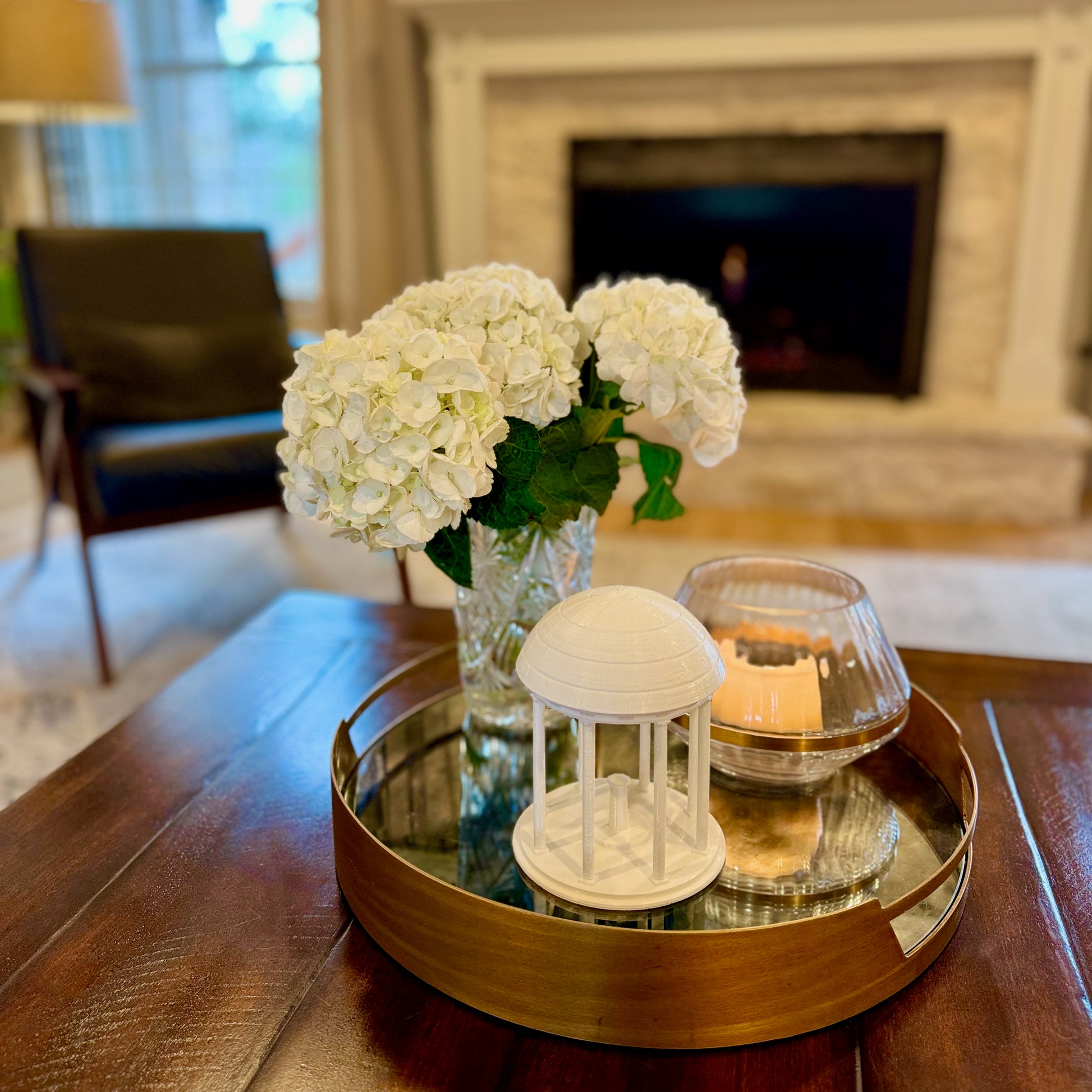 The larger Old Well figurine, shown styled in a living room.