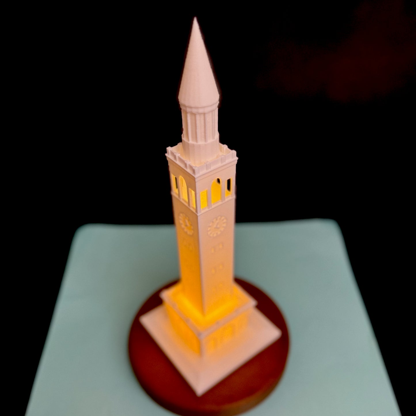 Top view of the University of North Carolina lamp, shown against a Carolina Blue background.