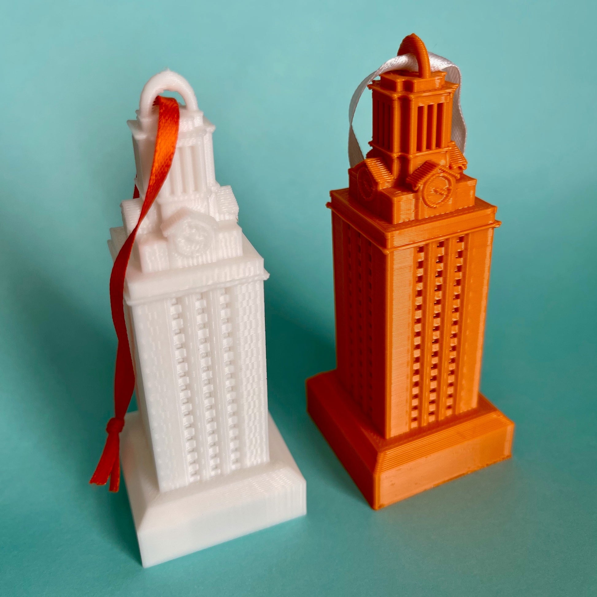 The UT Tower ornaments, shown in white and in burnt orange.