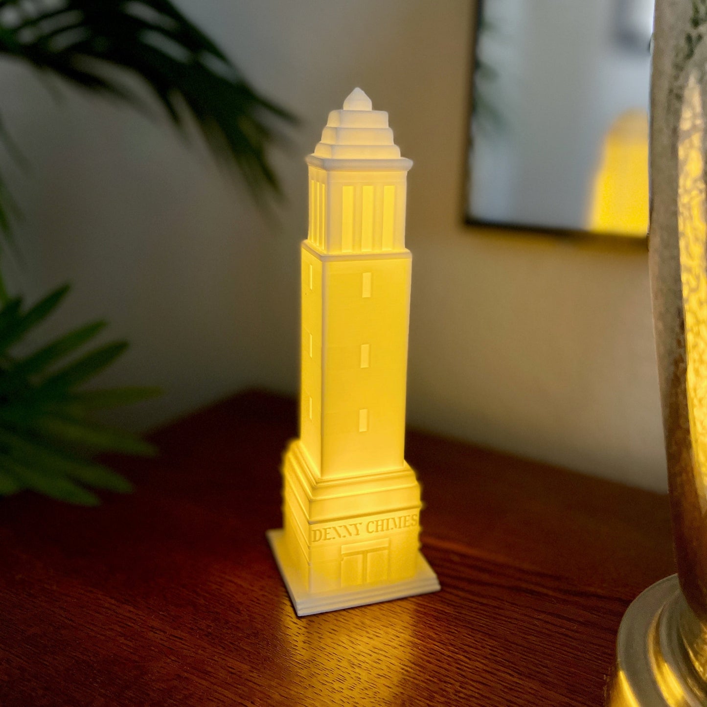 The University of Alabama Denny Chimes light, shown used as dorm decor on a side table.