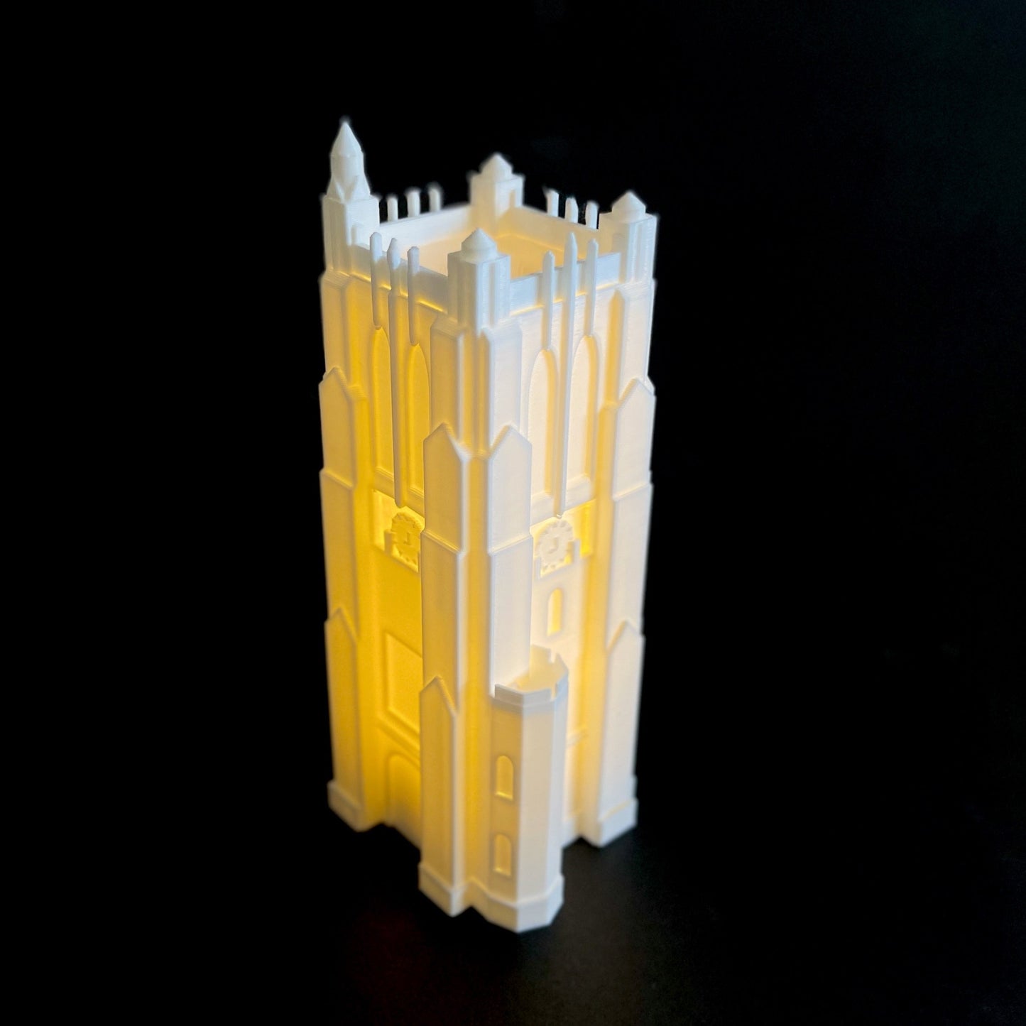 Side view of the lighted Michigan State desk accessory, a figurine designed as a replica of the Beaumont Tower campus building.