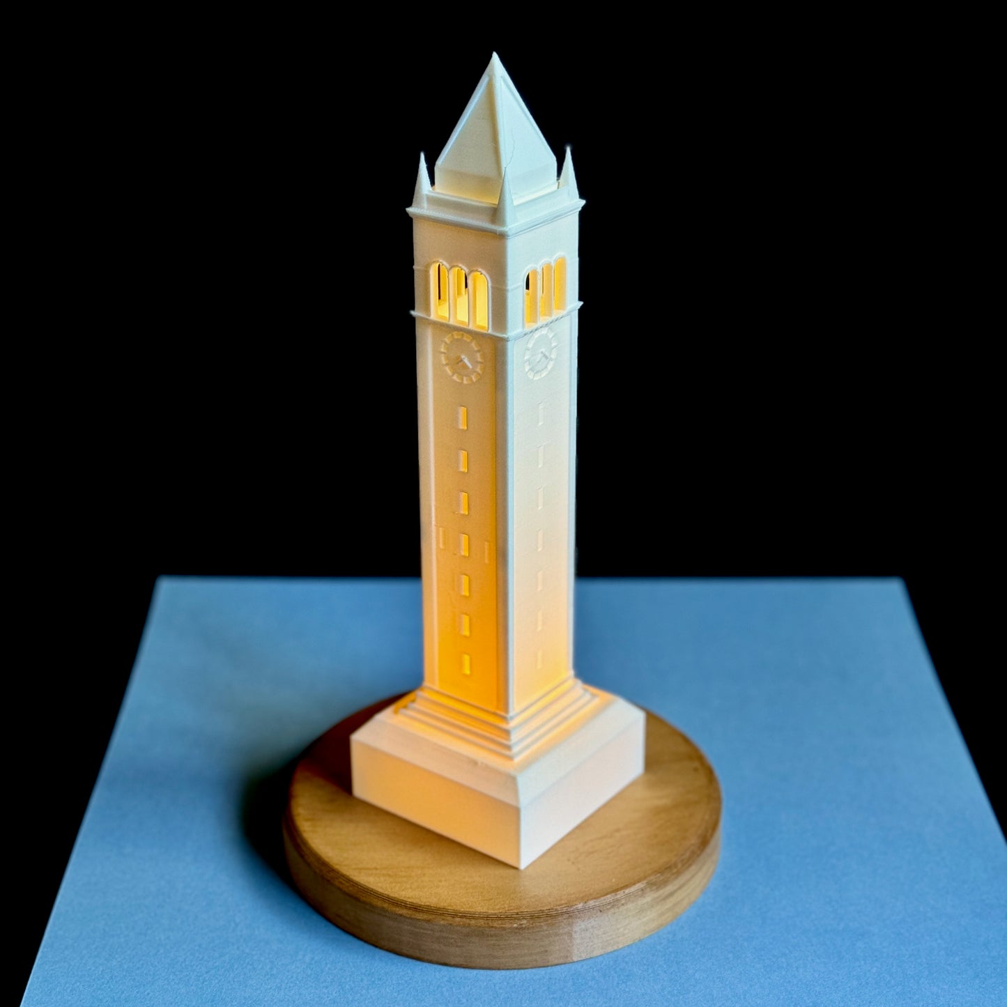 The Berkeley Campanile light, shown against a blue background.