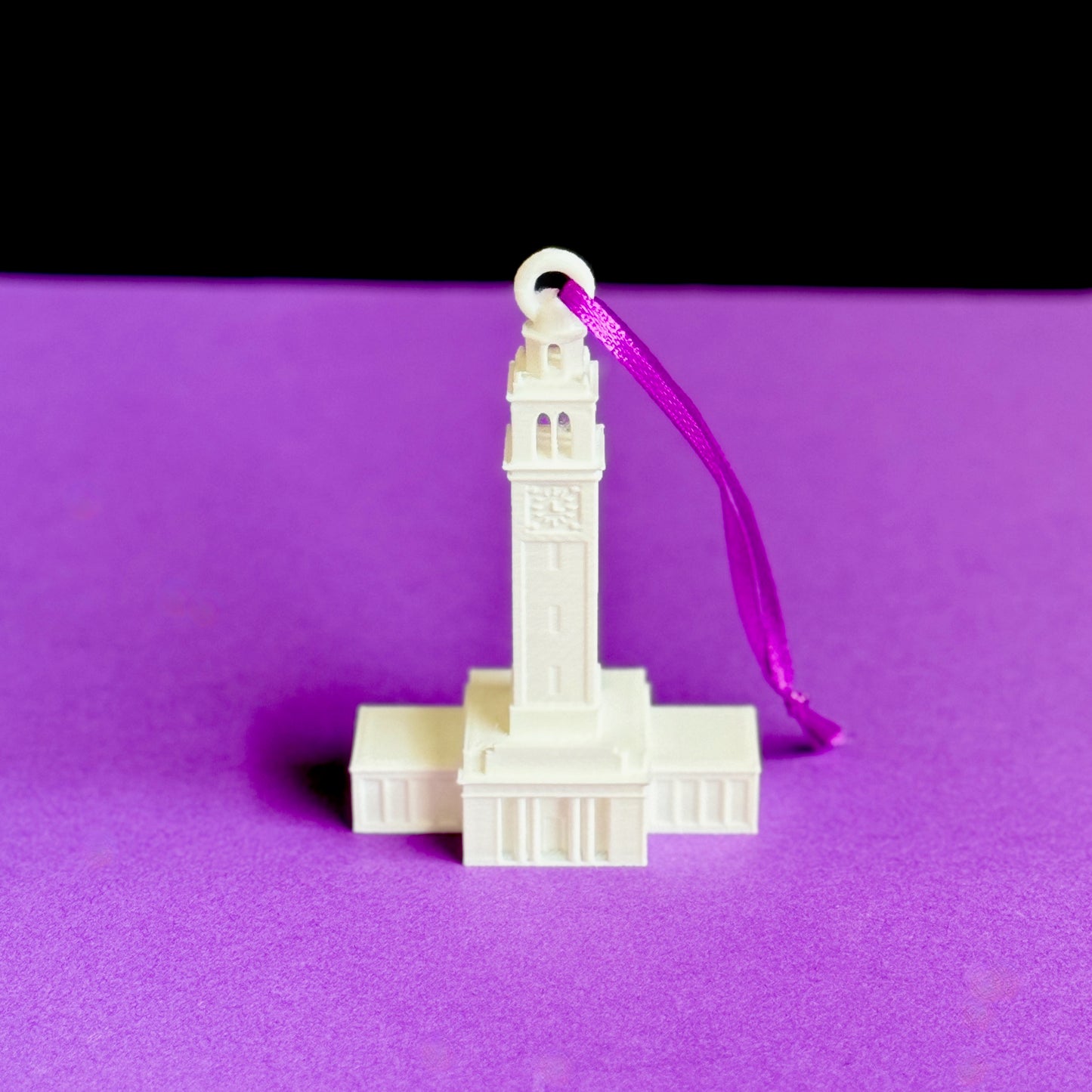 Front view of the LSU Christmas ornament depicting the Memorial Tower campus building.