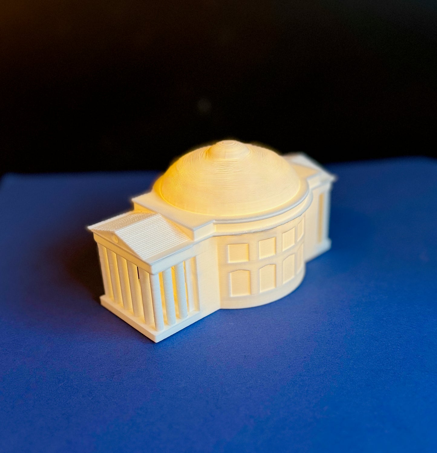 The UVA Rotunda light, shown against a blue background.