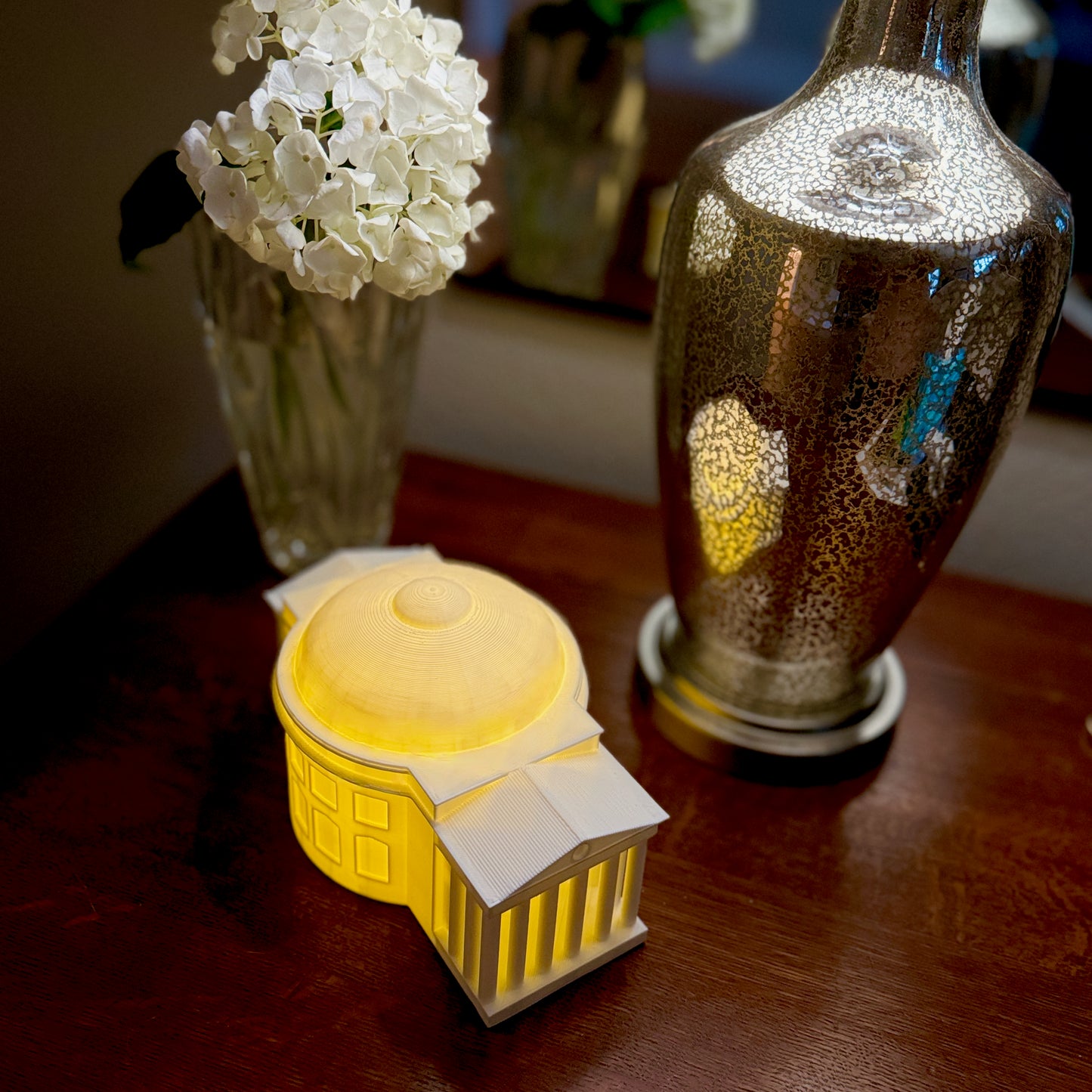 The UVA campus art print, shown on a bedroom side table.