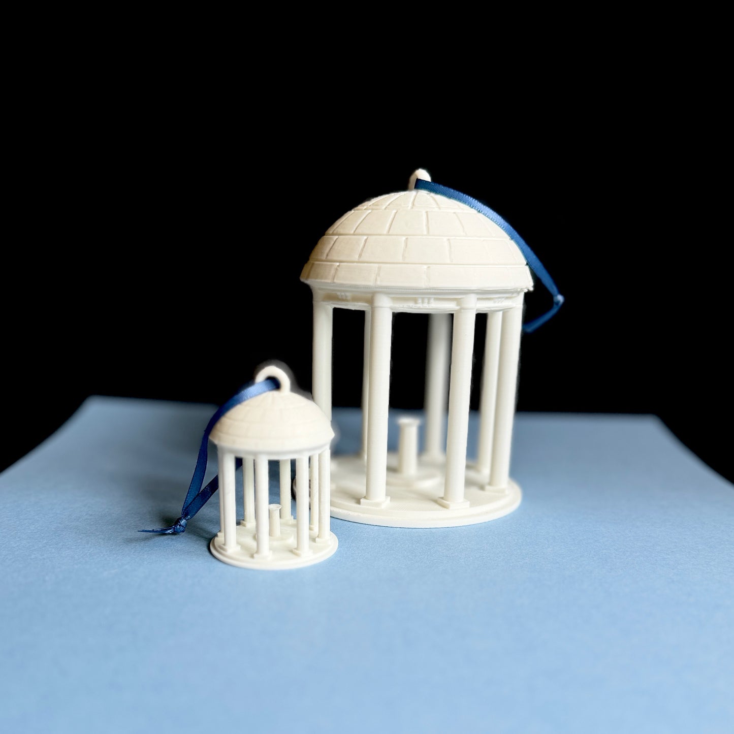 The UNC Old Well ornaments, shown in two sizes.