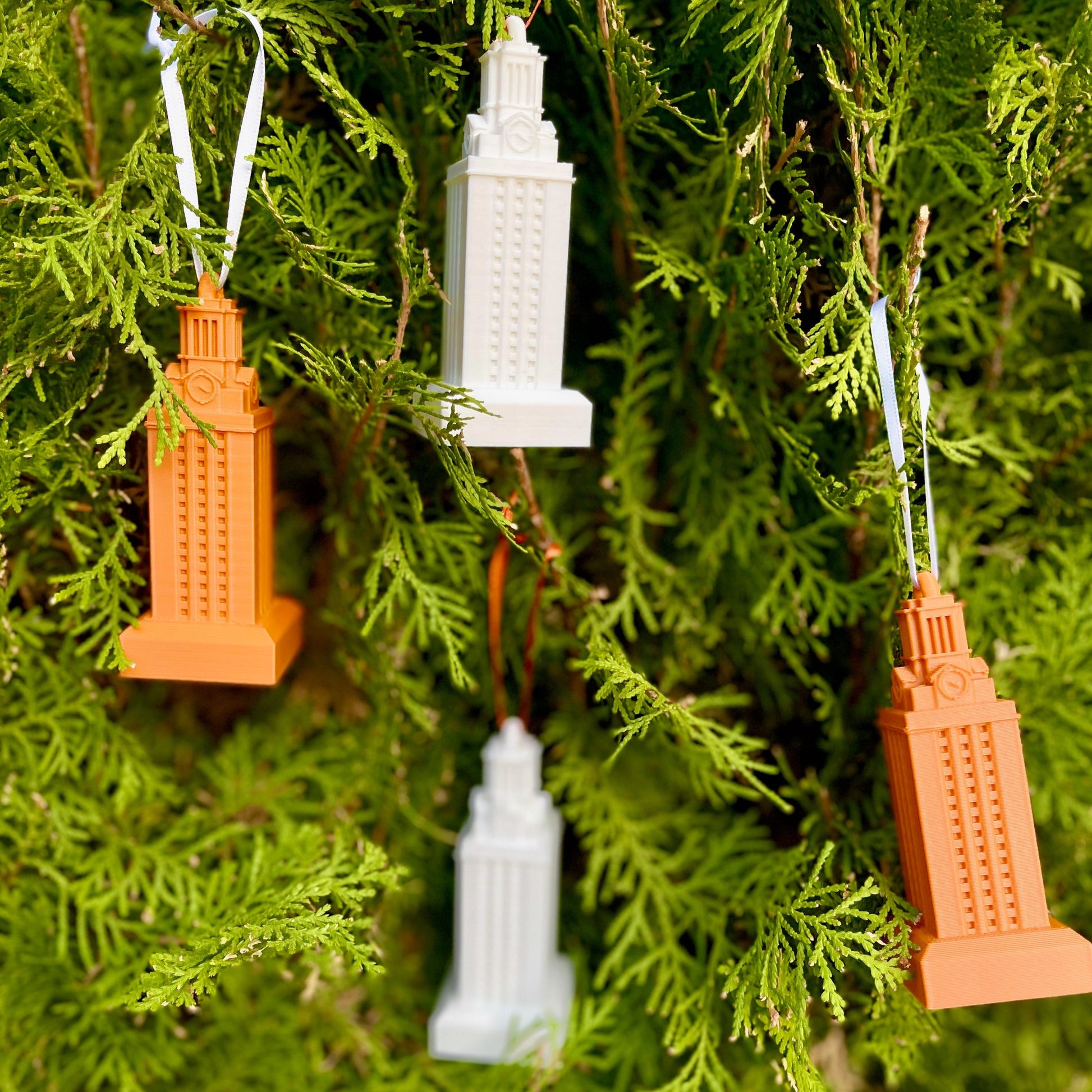 Multiple University of Texas ornaments, shown on a Christmas tree.