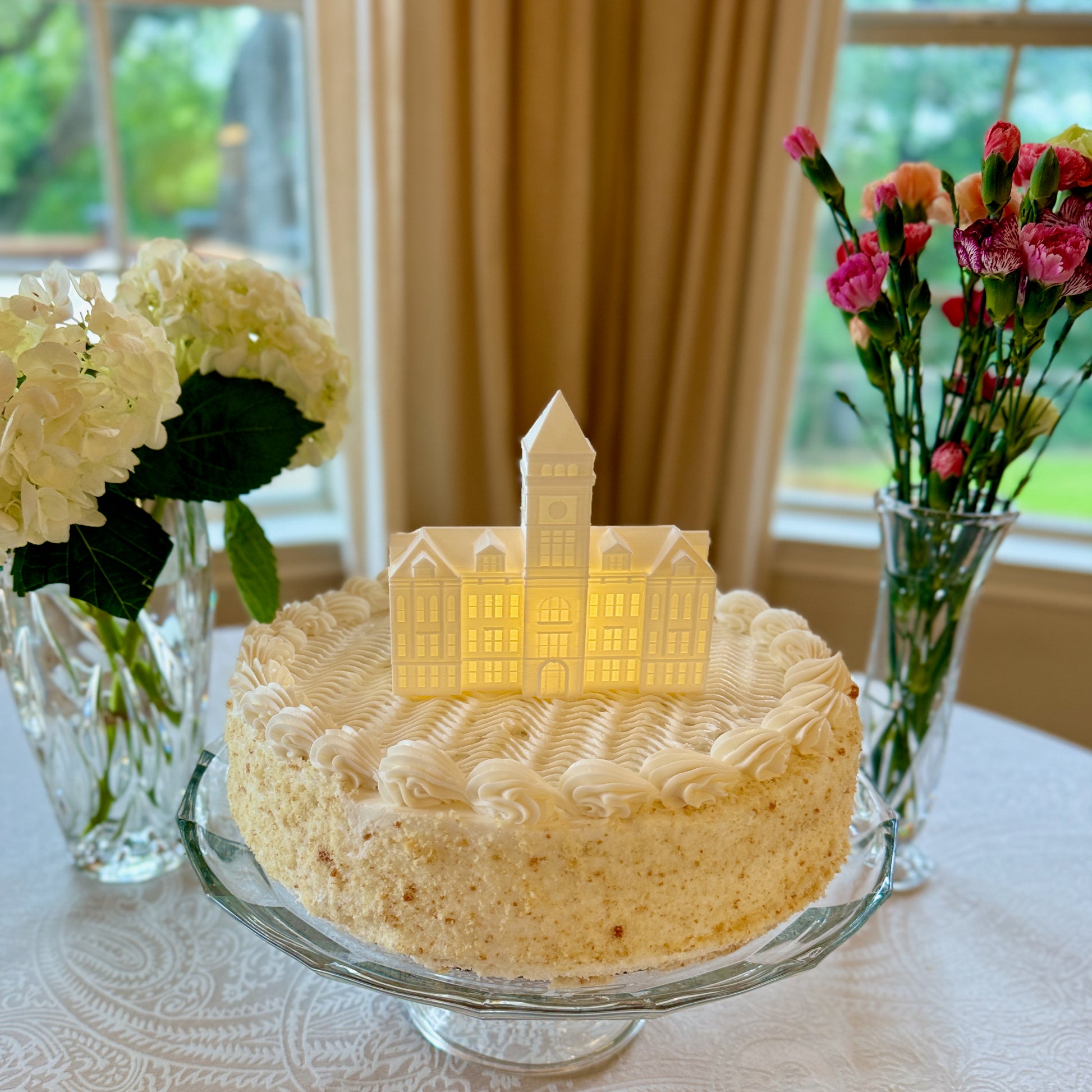 The lighted Clemson cake topper, representing Tillman Hall.