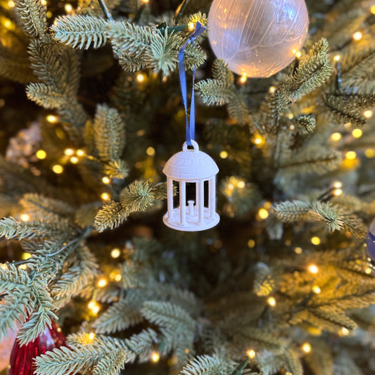 The UNC Old Well ornament, shown on a Christmas tree decorated for the Holidays.