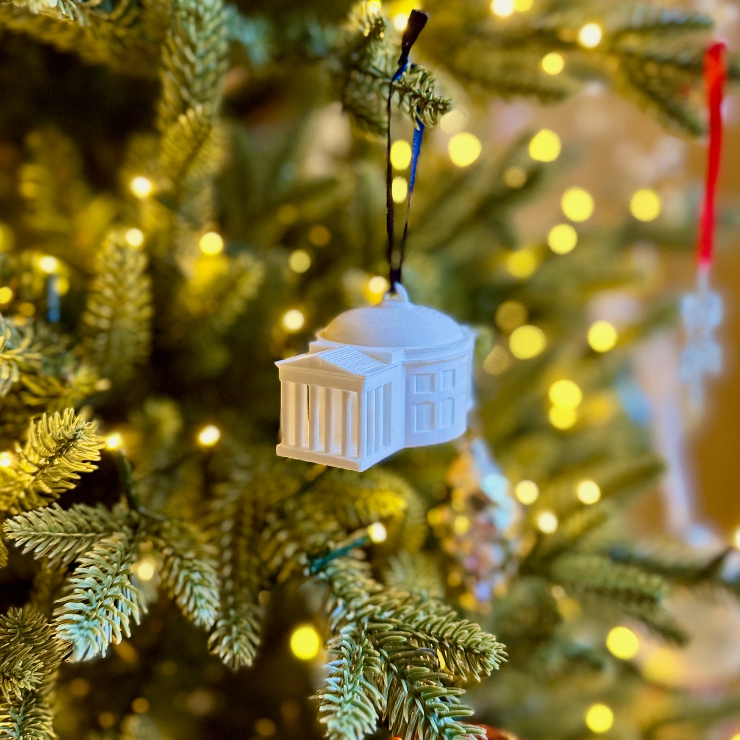 The UVA ornament shown on a Christmas tree.