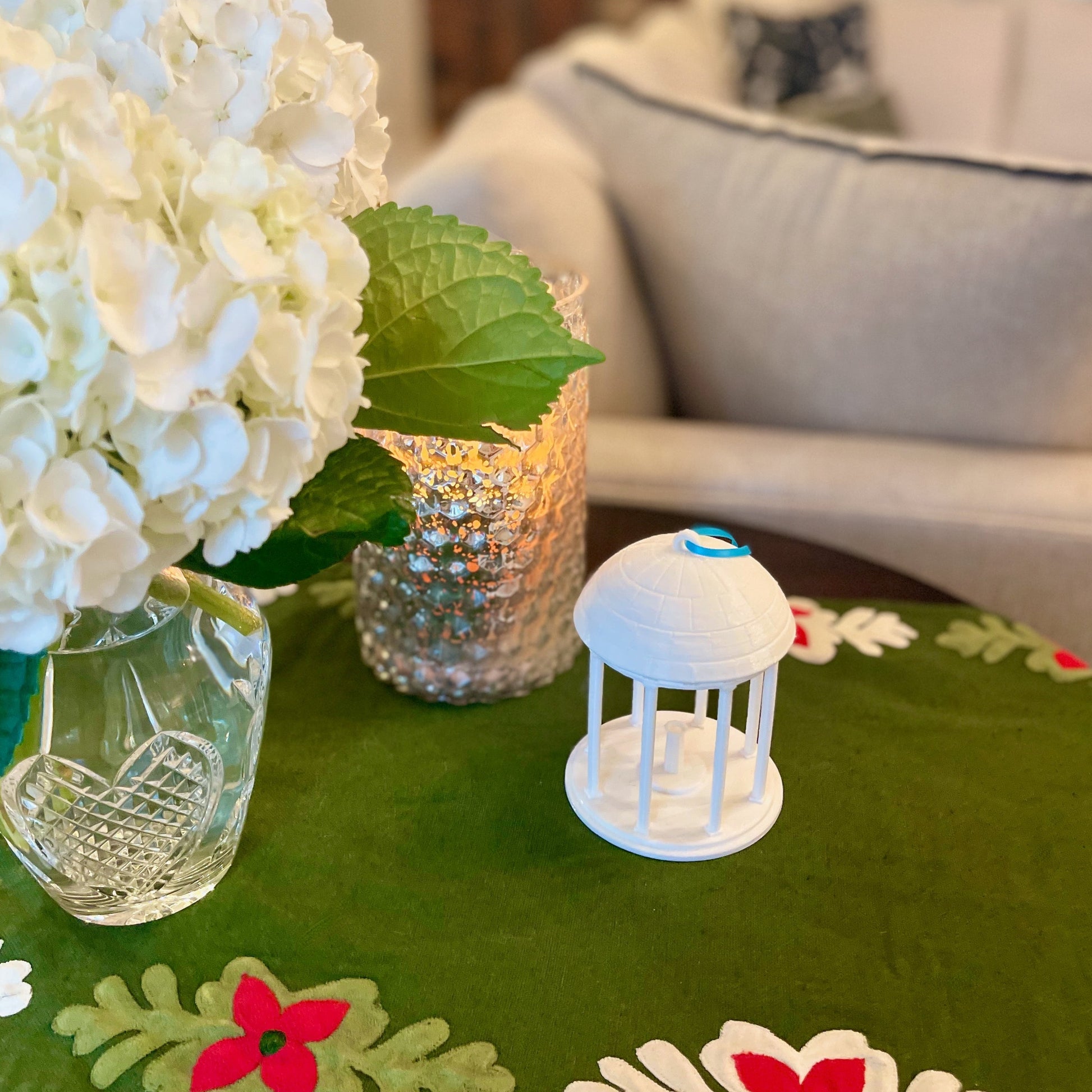 The UNC Old Well Christmas ornament, shown in a home decorated for Christmas.