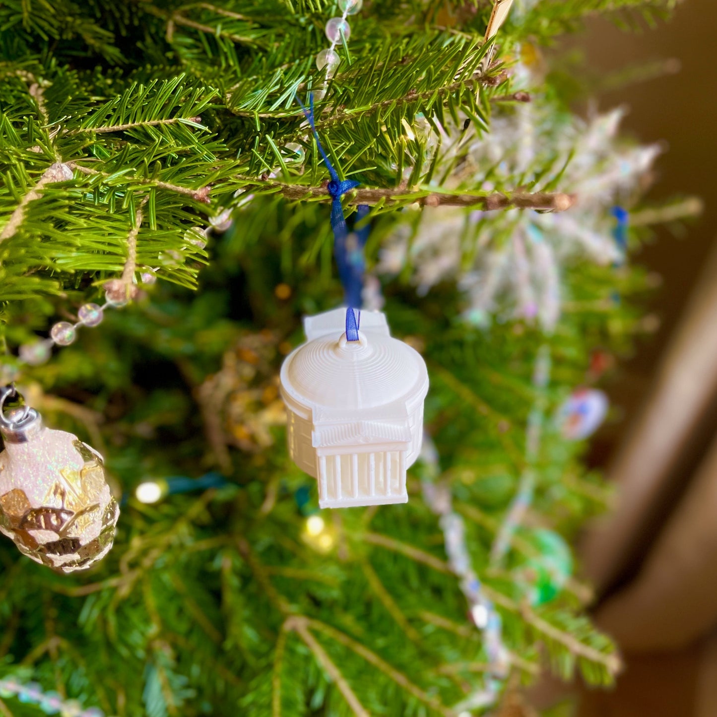 The UVA Rotunda ornament shown on a UVA tree decorated for Christmas.