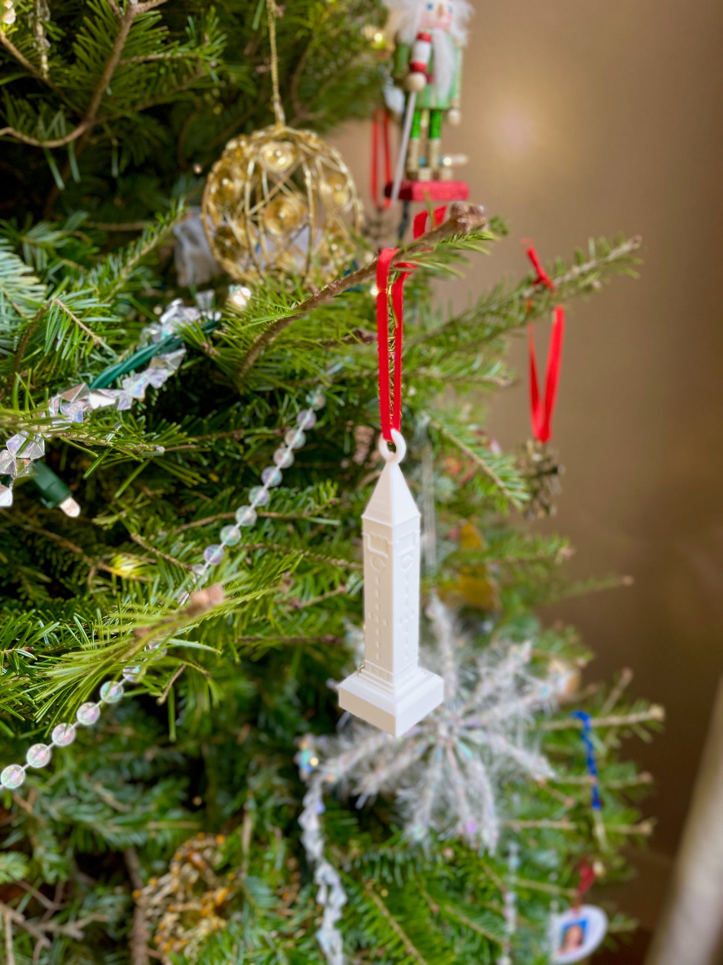 The Cornell ornament, shown on a Christmas tree.