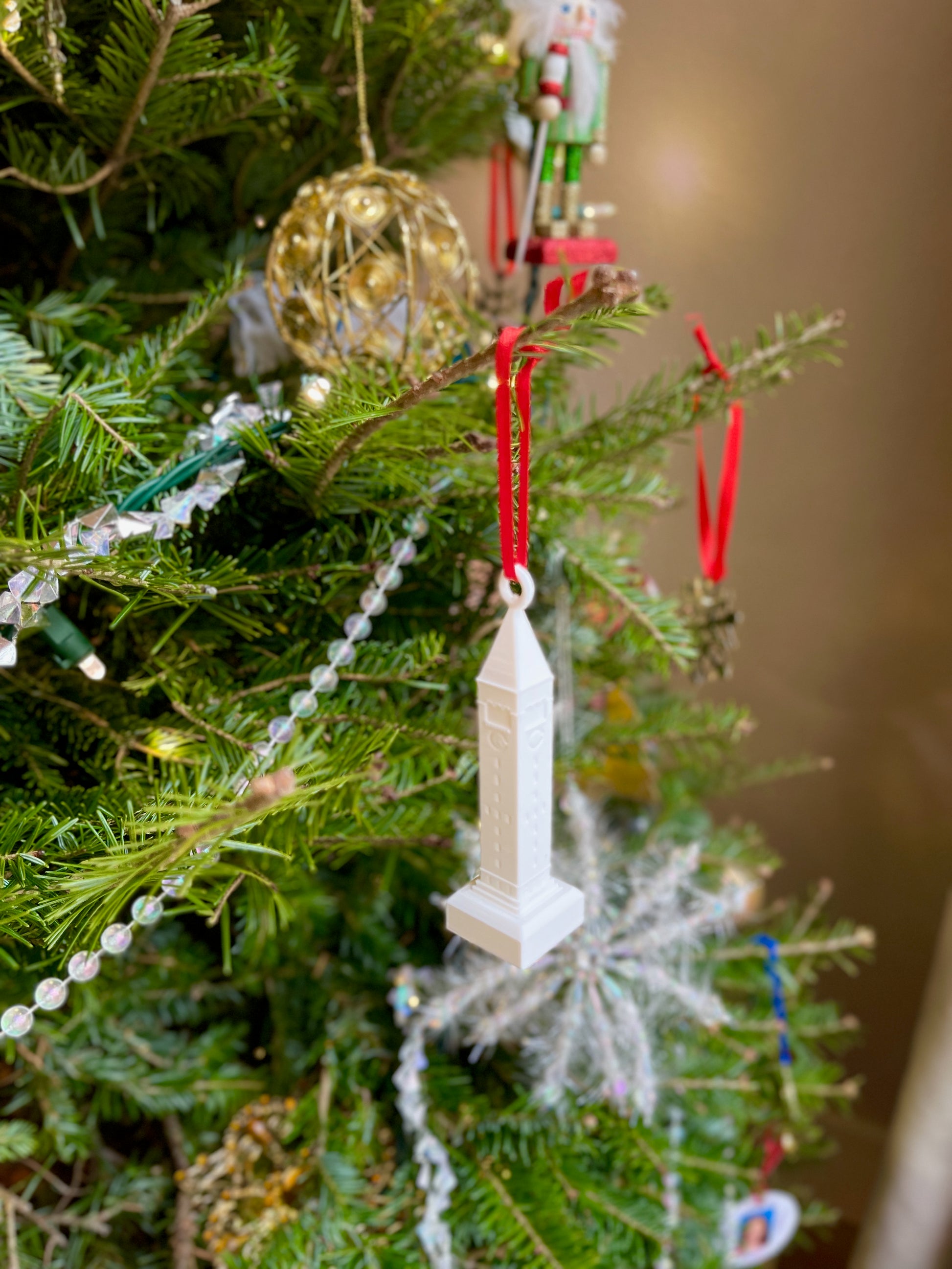 The Cornell ornament, shown on a Christmas tree.