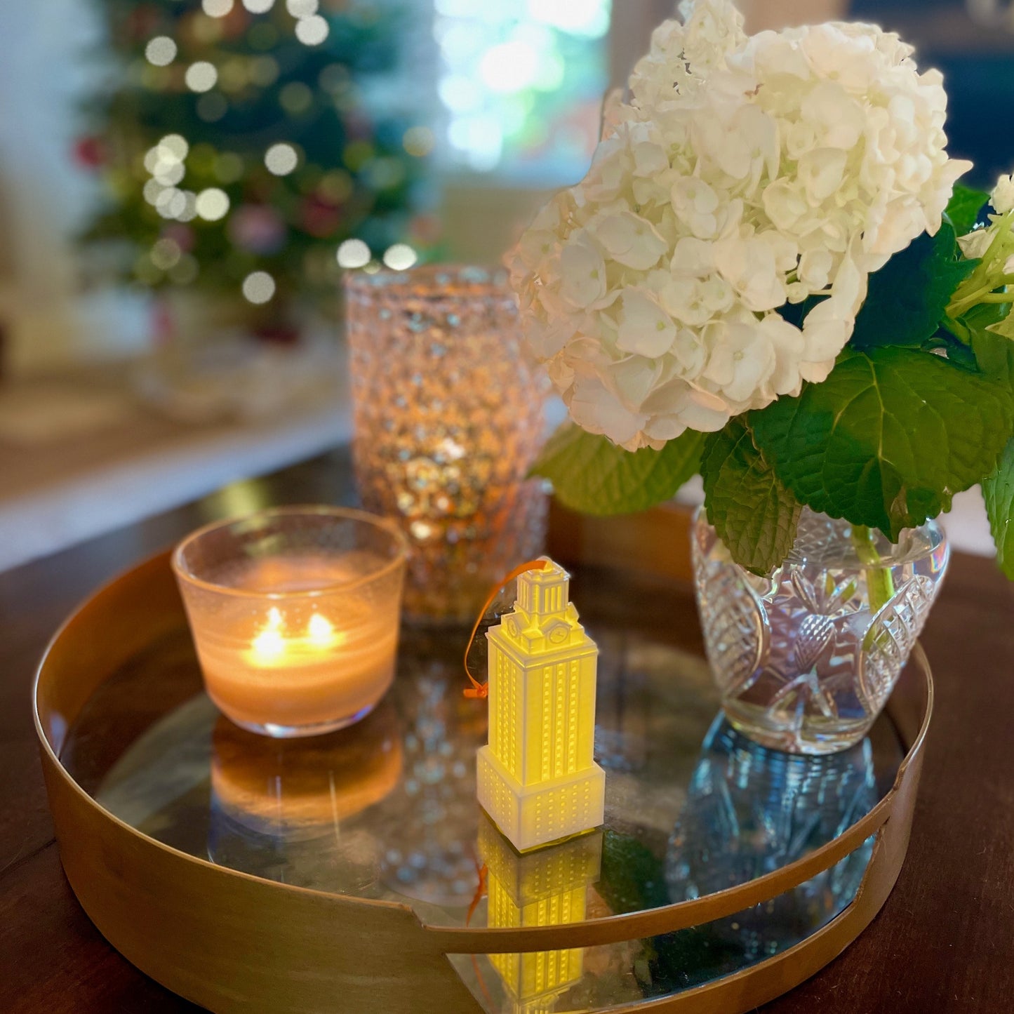 The UT Longhorns ornament, shown on a living room tray in a home decorated for Christmas.