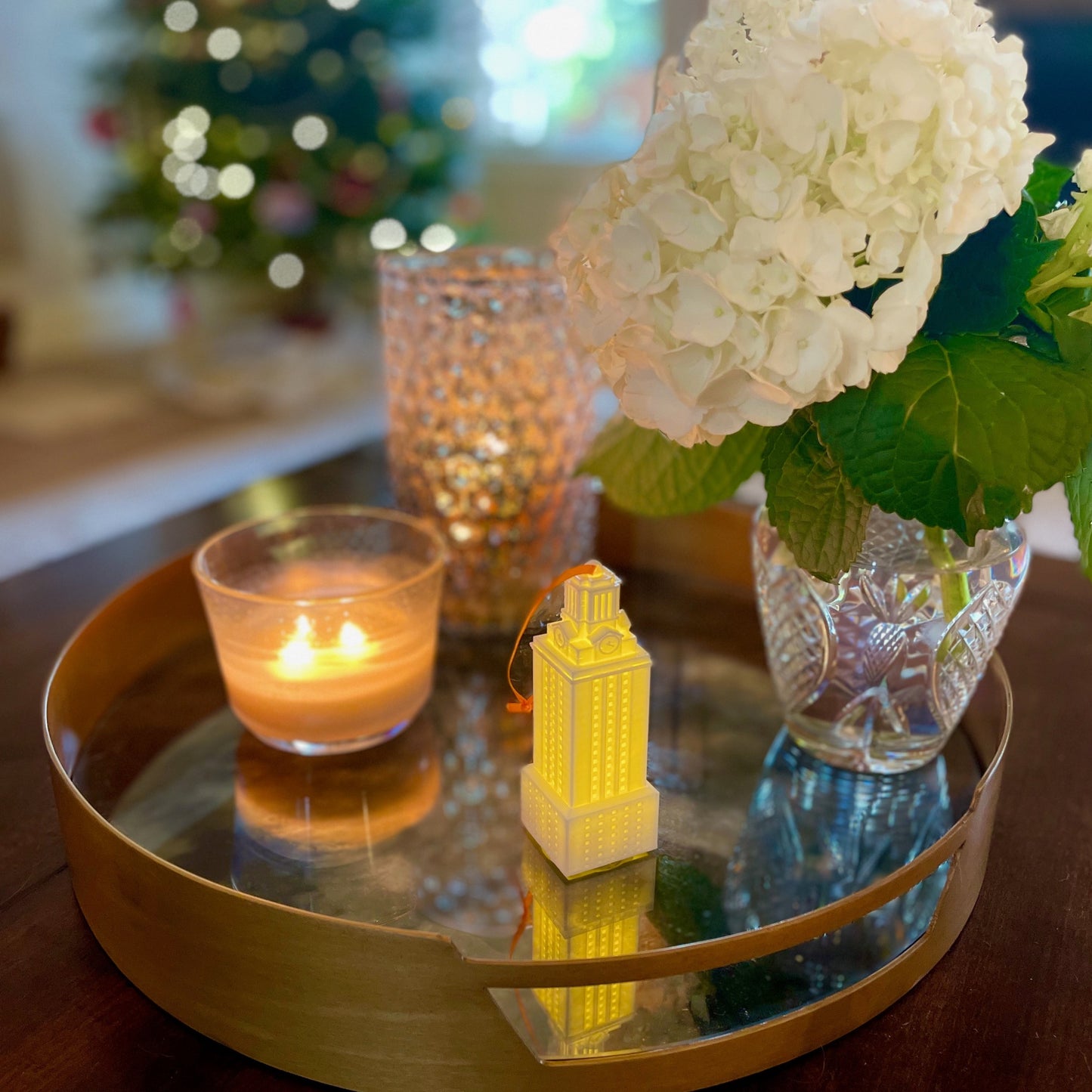 The University of Texas ornament with a light, shown in a home decorated for Christmas.