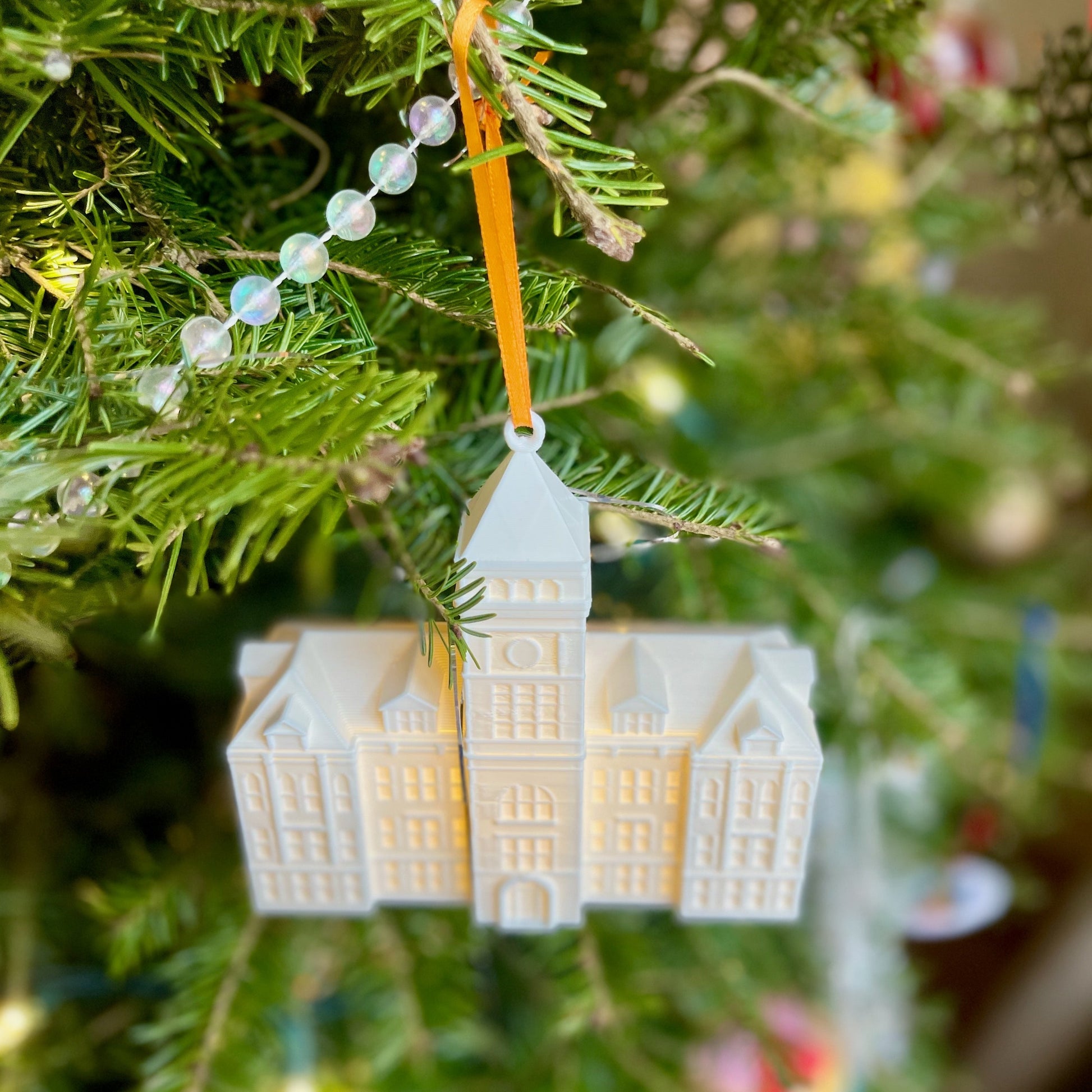 The Clemson ornament with a light, shown on a tree decorated for the Holidays.